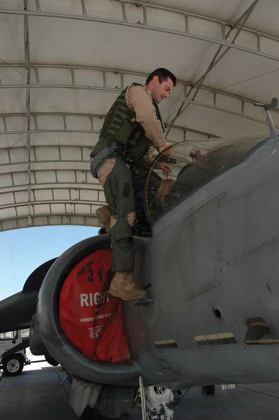 British Royal Air Force Squadron Leader Michael Baker, pilot, Marine Attack Squadron 513, climbs into the cockpit of an AV-8B Harrier jet here Monday. The Harrier is used by Italy, Spain, Britain and the United States.