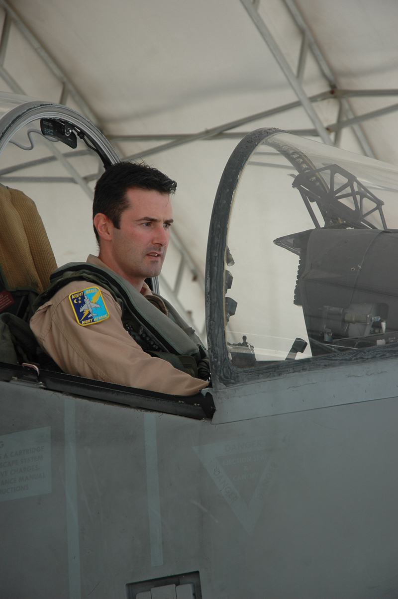 British Royal Air Force Squadron Leader Michael Baker, pilot, Marine Attack Squadron 513, sits in the cockpit of an AV-8B Harrier on the flightline here. The Harrier is a highly adaptable aircraft and used by many nations.