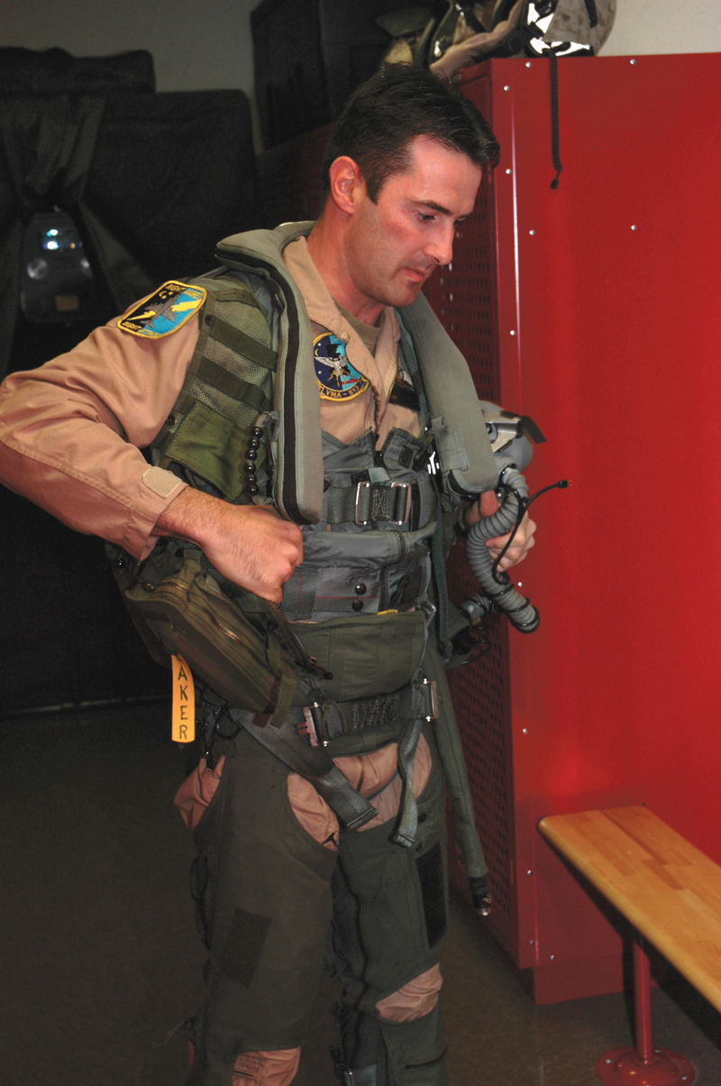British Royal Air Force Squadron Leader Michael Baker suit suits up in his flight suit at Marine Attack Squadron 513?s hangar here Monday. Baker, a pilot for VMA-513, is part of the pilot exchange program in which, a pilot spends two or three years stationed with a different country to learn their methods and tactics.