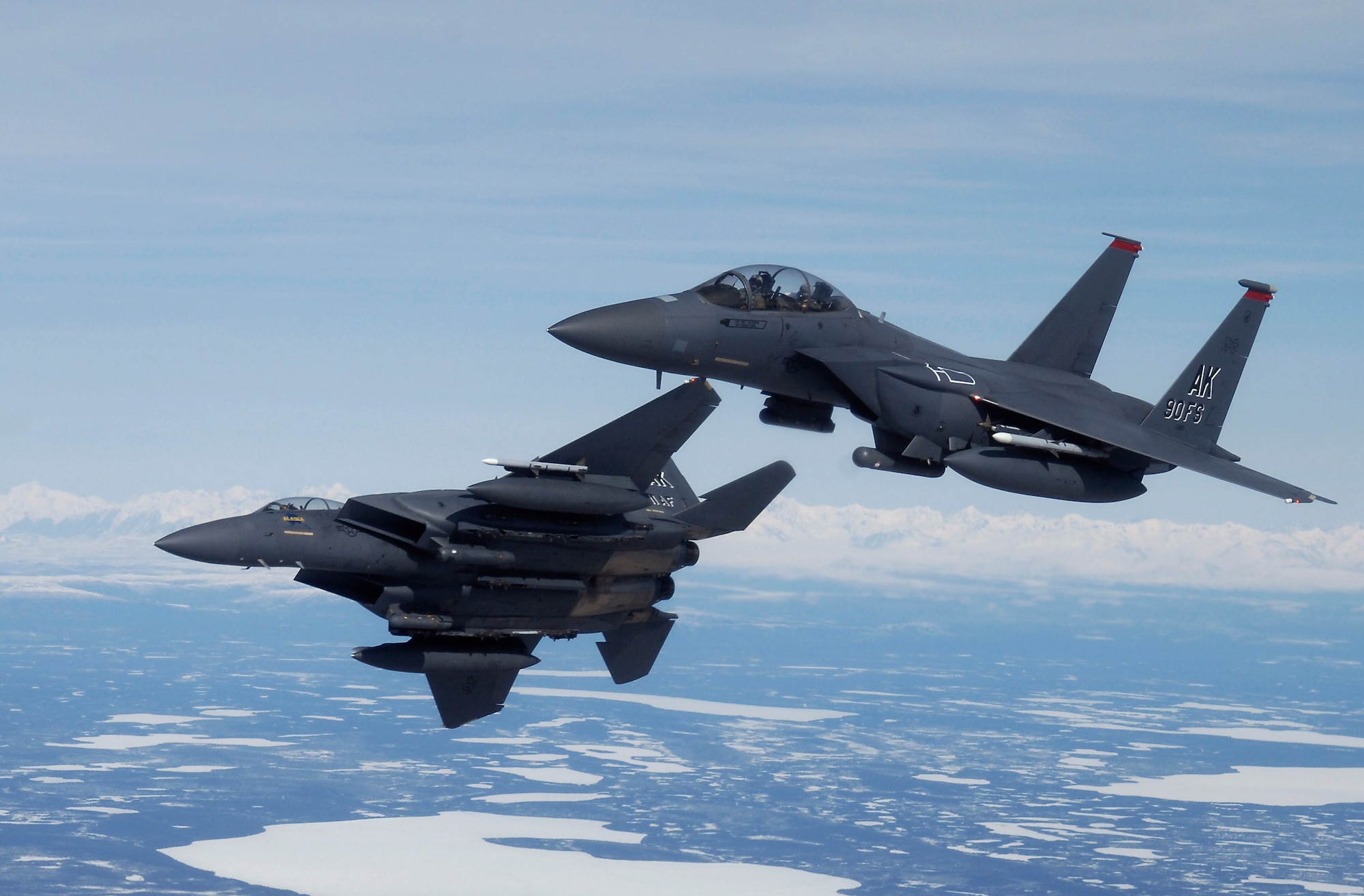 OVER ALASKA -- Two F-15E Strike Eagles assigned to Elmendorf Air Force Base, Alaska, manuver to bomb a ground target during a training flight. The Strike Eagle is assigned to the 90th Fighter Squadron, which traces its history back to August 1917. Another chapter in that rich history is about to be written as the F-15E at Elmendorf will soon be replace by the F-22A Raptor. (U.S. Air Force photo by Tech. Sgt. Keith Brown)