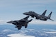 OVER ALASKA -- Two F-15E Strike Eagles assigned to Elmendorf Air Force Base, Alaska, manuver to bomb a ground target during a training flight. The Strike Eagle is assigned to the 90th Fighter Squadron, which traces its history back to August 1917. Another chapter in that rich history is about to be written as the F-15E at Elmendorf will soon be replace by the F-22A Raptor. (U.S. Air Force photo by Tech. Sgt. Keith Brown)
