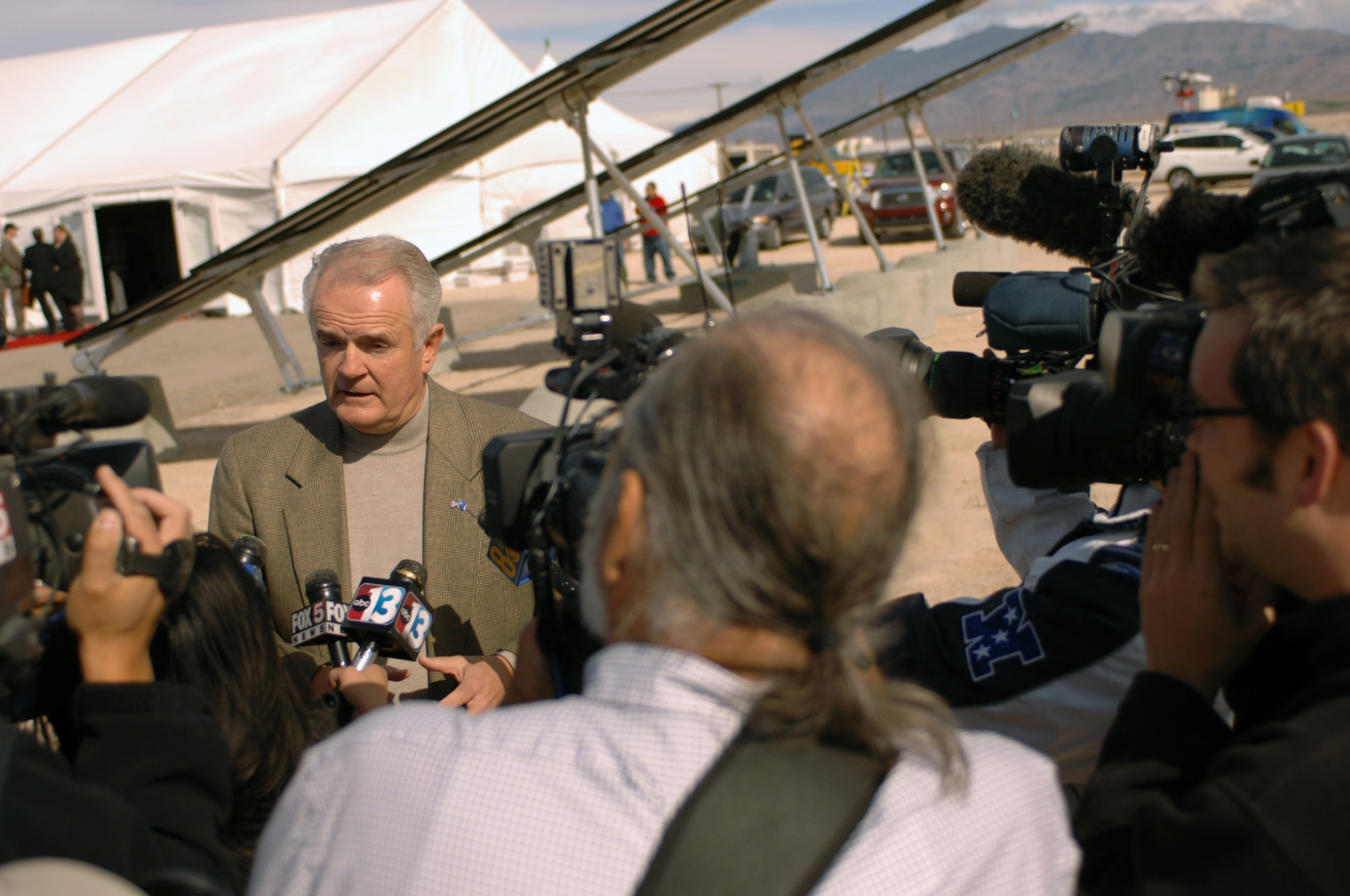 Nevada Governor Jim Gibbons speaks to members of the media at the Nellis Air Force Base solar power system's ground breaking ceremony, April 2. The Nellis solar power plant, scheduled for completion late 2007. The array is the largest photo-voltaic project in North America. The power plant will produce approximately 15 megawatts of power and provide nearly 30 percent of the electricity demand on the base which employs 12,000 people. (U.S. Air Force photo/Senior Airman Jason Huddleston)
