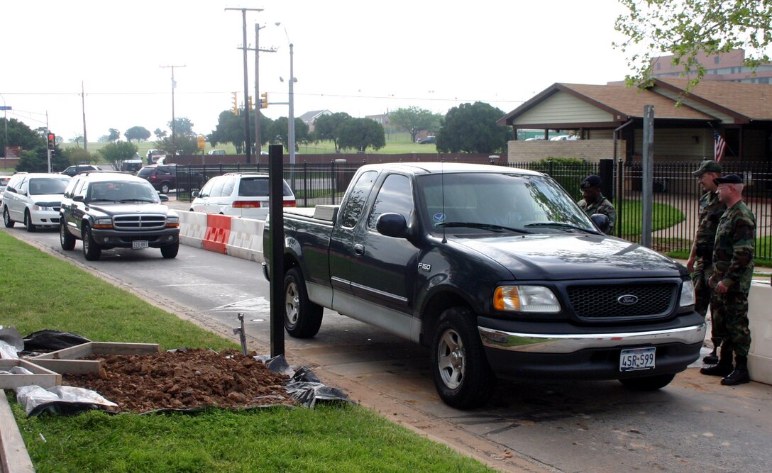 The road that usually serves as the exit for Capehart Housing serves as a two-lane entry/exit April 24, while construction workers install the keypad entry system on the customary entrance road. (U.S. Air Force photo/Staff Sgt. Tonnette Thompson)