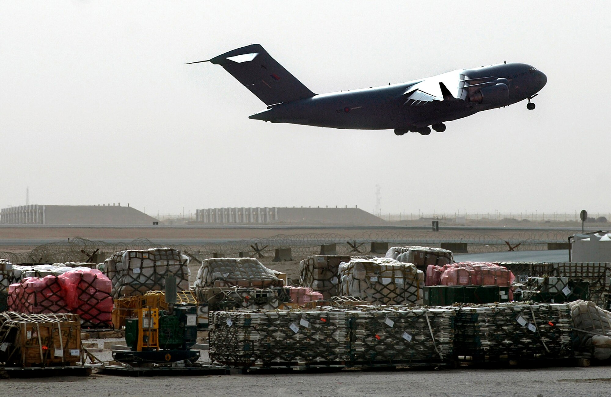 A Royal Air Force C-17 takes off to support operations in Iraq. RAF and U.S. Air Force C-17s  provide strategic and intra-theater heavy airlift support to coalition forces as part of a multi-nation team. The C-17 is a four-engine turbofan aircraft capable of carrying large payloads over intercontinental ranges without refueling. It is designed to allow delivery of oversized combat cargo and equipment directly into austere airfields. (U. S. Air Force photo/Tech. Sgt. Cecilio M. Ricardo Jr.)
