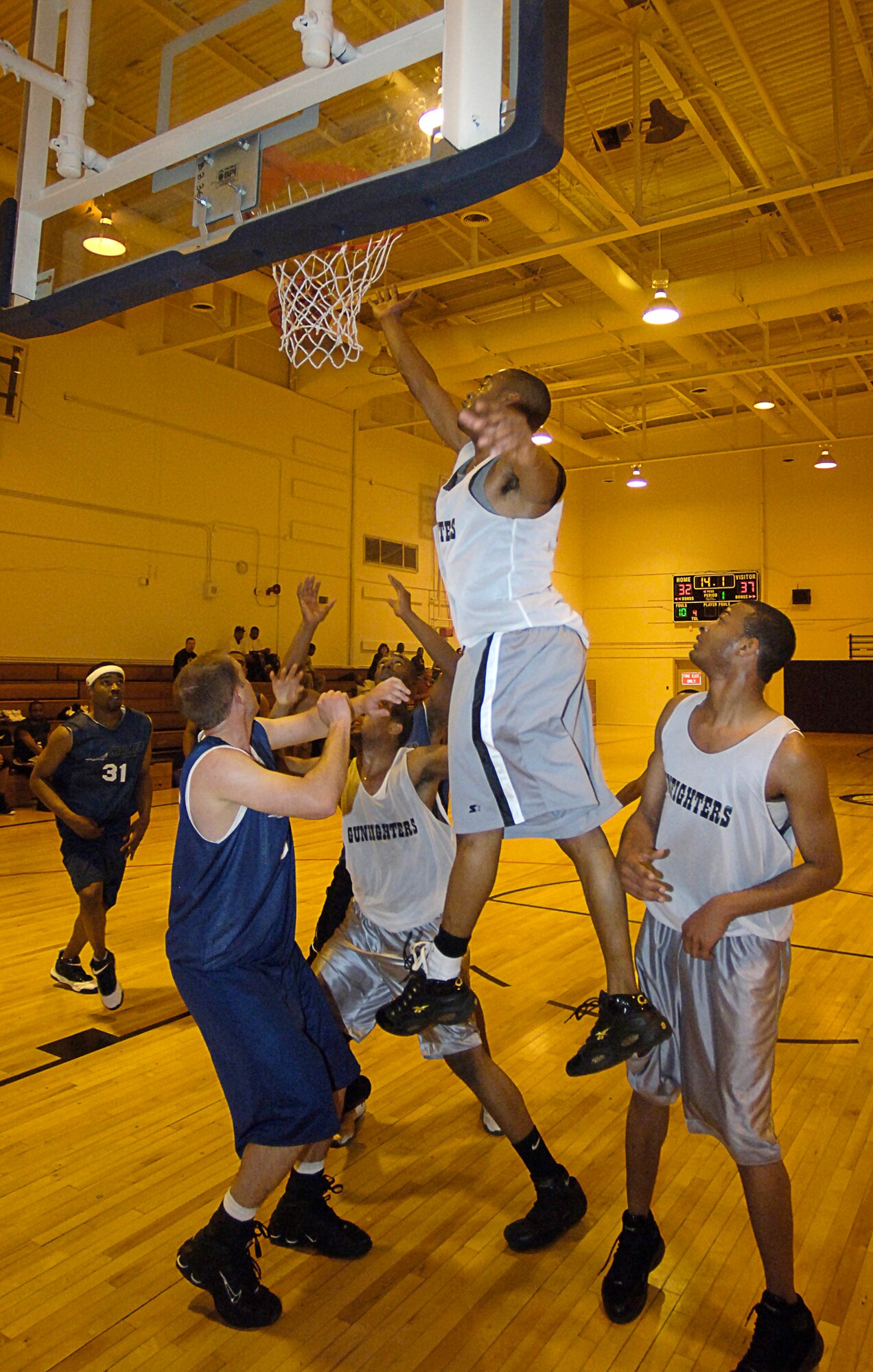 MOUNTAIN HOME AIR FORCE BASE, Idaho -- Players from Hill Air Force Base, Utah, clash with Gunfighters as they scramble for the rebound during a varsity scrimmage here April 20. The teams faced off April 20 to 22 with both teams claiming two victories each. Air Force photo by Airman 1st Class Ryan Crane