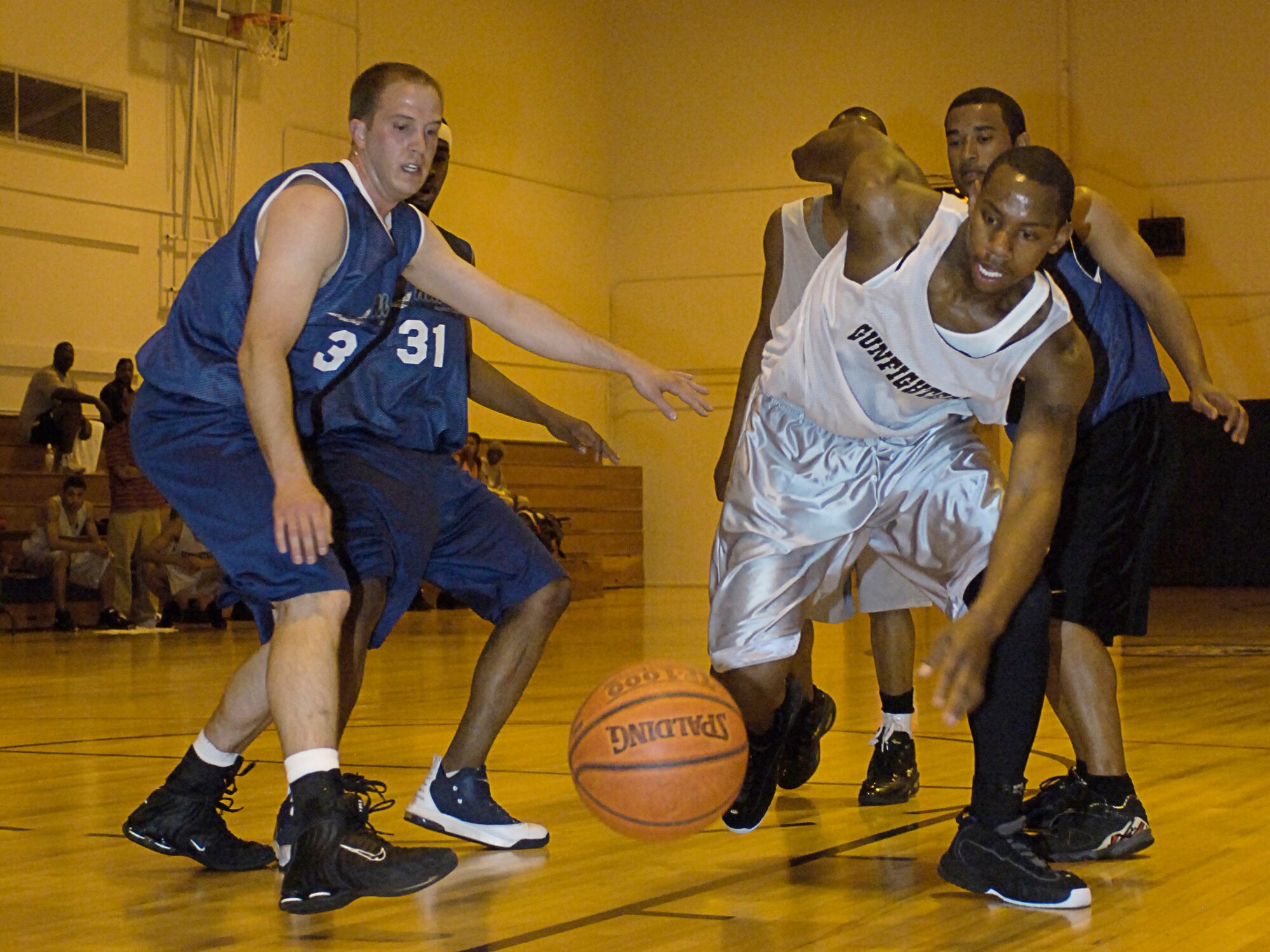 MOUNTAIN HOME AIR FORCE BASE, Idaho -- Robert Holmes from the Gunfighters and Andrew Mimms from the Hill Air Force Base, Utah, race for possession of the ball during a varsity scrimmage here April 20. The teams faced off April 20 to 22 with both teams claiming two victories. Air Force photo by Airman 1st Class Ryan Crane