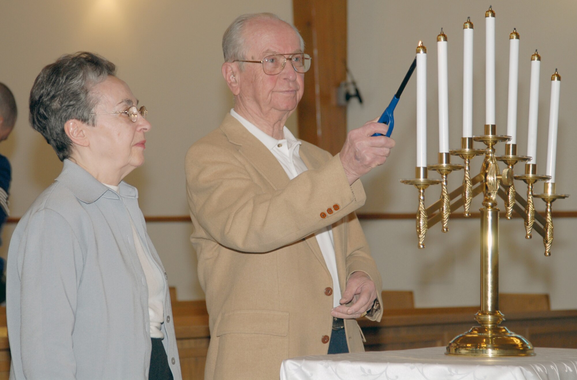 Brother and sister Helen Zigmund and Zola Gancz light candles during the Holocaust remembrance candle lighting ceremony in the High Plains Chapel April 16 to honor those lost and affected by the Holocaust. They are both local survivors of the Holocaust (Photo by Shelley Raffl).