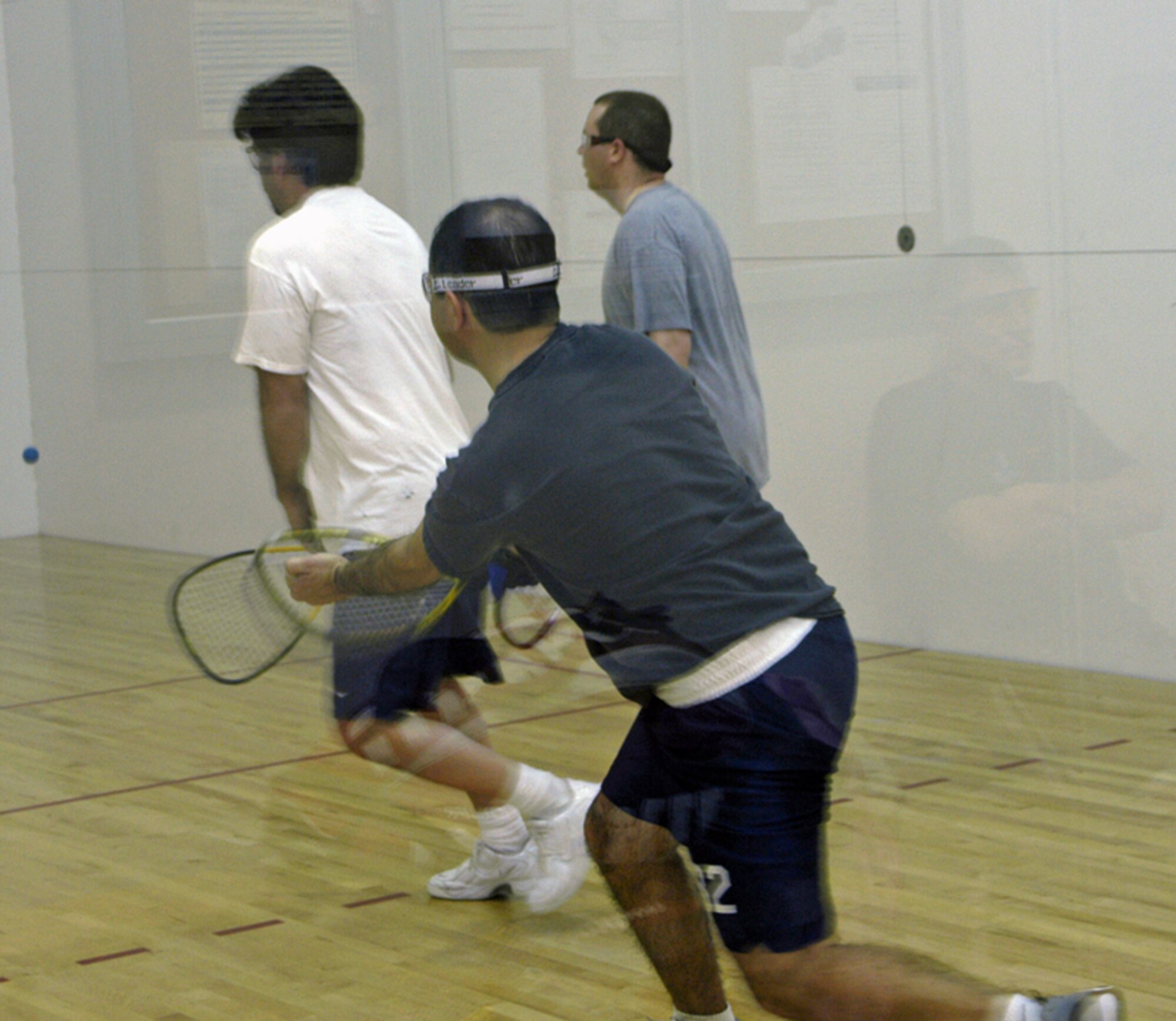 From left to right: Jerry Padilla, 90th Civil Engineering Squadron, Maj. Mike Emerson, 30th Airlift Squadron, and Senior Airman Jason Hanna, 90th CES, play doubles racquetball in the intramural racquetball championship April 6 in Freedom Hall. The 30th AS #1 team took first place after winning three games against the 90th CES and the 90th Medical Operations Squadron teams (Photo by 2nd Lt. Lisa Meiman).