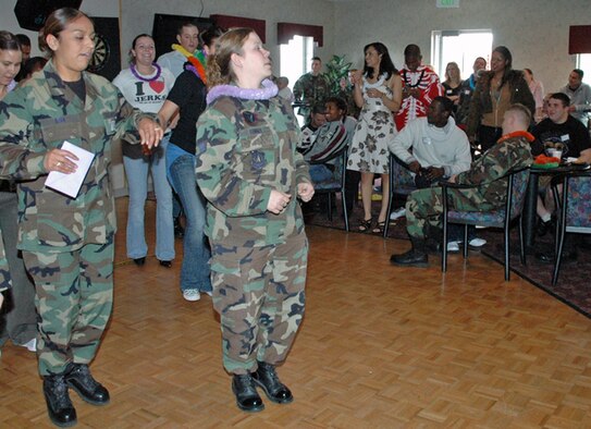 Staff Sgt. Andrea Kenney, 90th Security Forces Squadron and Senior Airman Veronica Sena, 90th Medical Operations Squadron, take two hops for the Cha-cha Slide while sharing the dance floor with attendees of the Rising 6 icebreaker April 13. Warren members crowded the Trail's End club to attend the event, which was thrown to promote the newly-formed Rising 6 council. Rising 6 has its meetings on the last workday of every month in the Trail's End club at 4 p.m. immediately following the 3:30 p.m. promotion ceremony (Photo by Airman Alex Martinez).