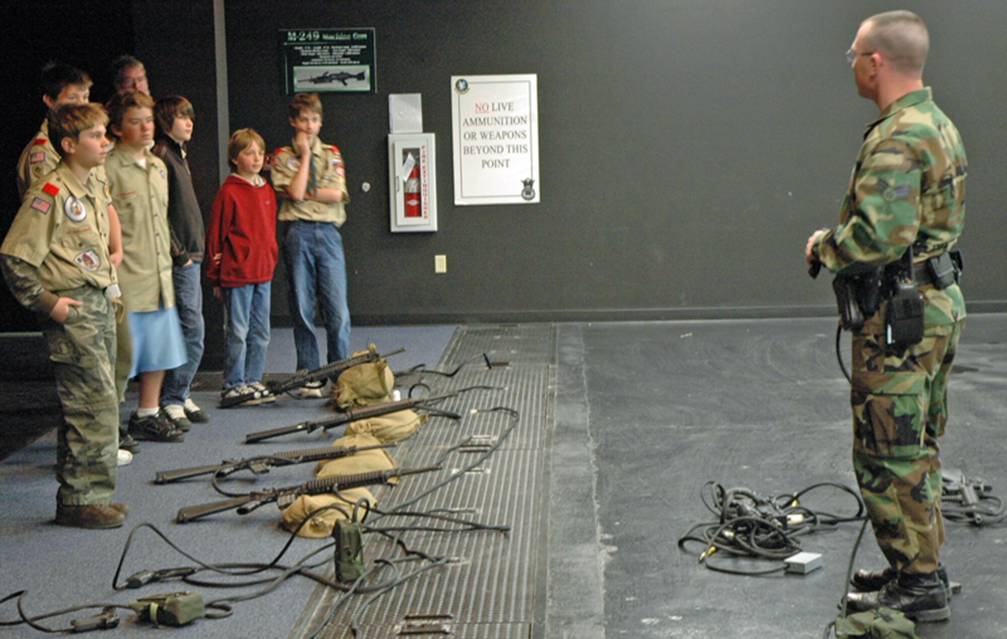 Senior Airman Kevin Gallagher, 90th Security Support Squadron, briefs local Boy Scouts on the different types of weapons and scenarios for the fire arms training system April 14. The Boy Scouts were on a familiarization tour of Warren (Photo by Airman Alex Martinez).