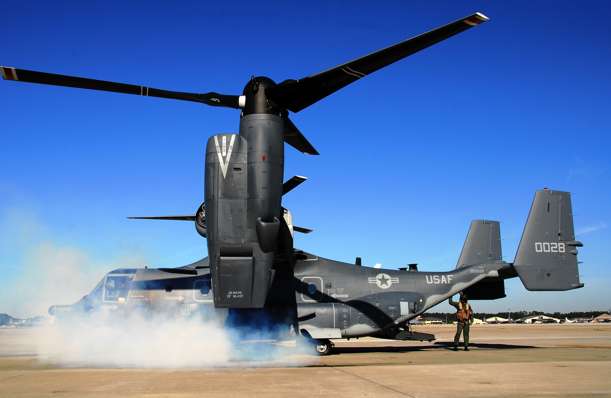 Smoke billows as an 8th Special Operations Squadron CV-22 Osprey prepares for takeoff. The mission was to perform the first military freefall jump from an Air Force Special Operations Command CV-22. (US Air Force photo by Chief Master Sgt. Gary Emery)