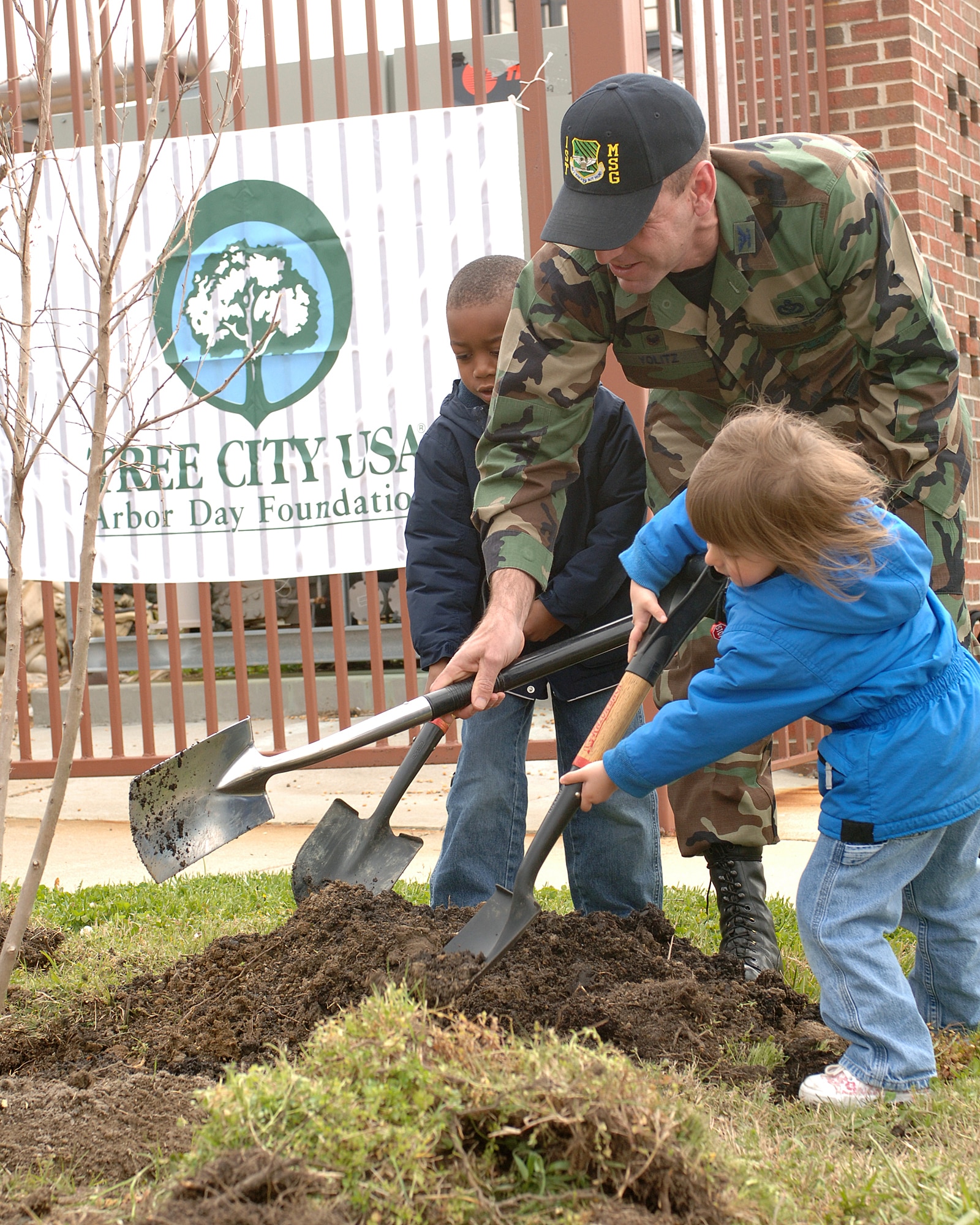 LANGLEY AIR FORCE BASE, Va. -- Col. Brian Yolitz, 1st Mission Support Group commander, along with Lawrence Johnson, son of Master Sgt. Lester and Tech. Sgt. Latricia Johnson, and Anna Tingley, daughter of Majors Christopher and Laurel Tingley, plant a tree in front of the Russ Child Development Center April 20. Colonel Yolitz spoke on behalf of the 1st Fighter Wing commander, Brig. Gen. Burt Field, emphasizing the need for environmental protection. (U.S. Air Force photo/Airman 1st Class Giang Nguyen)
