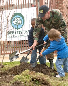 LANGLEY AIR FORCE BASE, Va. -- Col. Brian Yolitz, 1st Mission Support Group commander, along with Lawrence Johnson, son of Master Sgt. Lester and Tech. Sgt. Latricia Johnson, and Anna Tingley, daughter of Majors Christopher and Laurel Tingley, plant a tree in front of the Russ Child Development Center April 20. Colonel Yolitz spoke on behalf of the 1st Fighter Wing commander, Brig. Gen. Burt Field, emphasizing the need for environmental protection. (U.S. Air Force photo/Airman 1st Class Giang Nguyen)