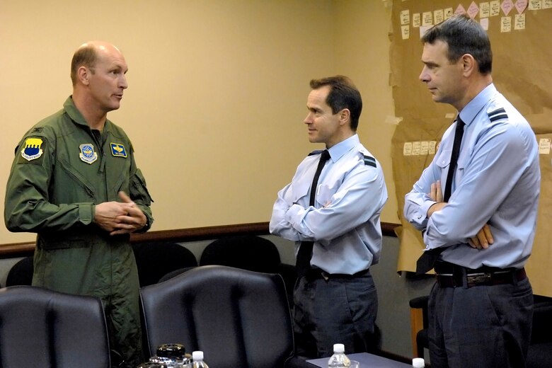 Royal Air Force Air Vice Marshal Peter Dye (right) and Air Commodore Doug Gale listen to Col. Timothy Zadalis explain the merits of the Air Force Smart Operations for the 21st century April 20 at Pope Air Force Base, N.C. Air Vice Marshall Dye is the director of transformation for the RAF, and Air Commodore Gale is the head of delivery on the RAF transformation program. Colonel Zadalis is the commander the 43rd Airlift Wing. (U.S. Air Force photo/Mike Murchison)