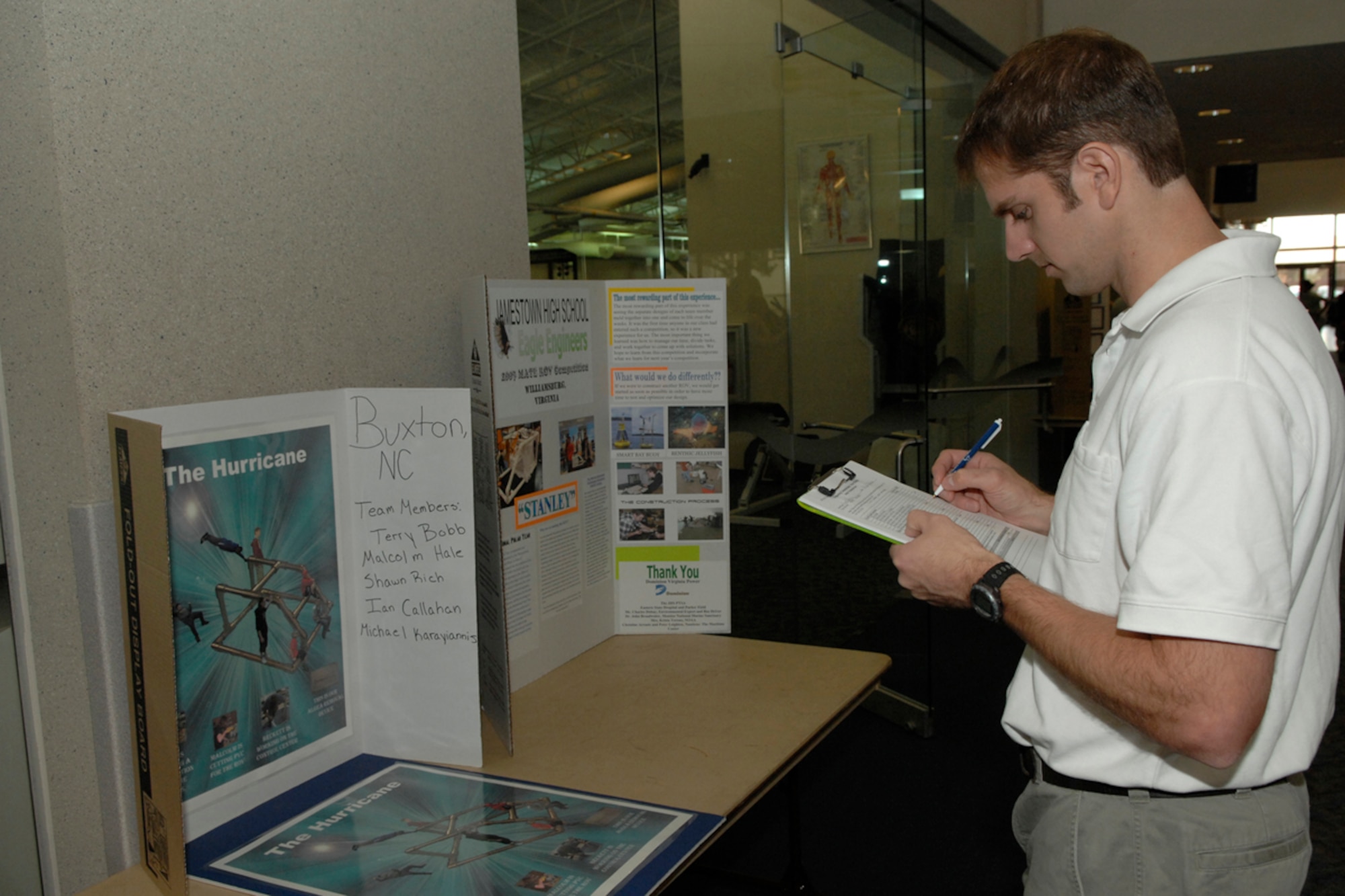 Ralph Kuehn, NASA Langley scientist, judges science projects to determine the winner of the Remotely Operated Vehicle Competition at the Shellbank Fitness Center April 21. Students from twelve different high schools throughout North Carolina, Virginia, and Maryland traveled to Langley to participate in the competition. (U.S. Air Force photo/Airman Aaron Johnson)