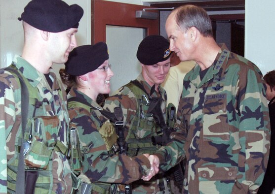 Gen. Kevin P. Chilton, Air Force Space Command commander, greets (left to right) Airman 1st Class Joe Ramey, Airman 1st Class Heidi Allen and  Staff Sgt. Terry Greis, from the 790th Missile Security Forces Squadron, before descending to the launch control center at missile alert facility Alpha-01 April 10. Ten members of the Air Force Civic Leader Group visited Warren as part of a larger AFSPC familiarization tour  (Photos by Bernie Ernst).