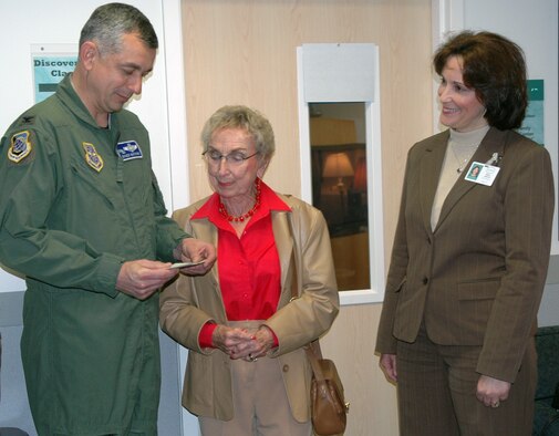 FAIRCHILD AIR FORCE BASE, Wash. -- Col. Roger Watkins, 92nd Air Refueling Wing vice commander, accepts on behalf of the wing and Airman and Family Readiness Center a $1,000 check from Martha Lu Butler, a resident of Waterford on South Hill and originator of the campaign, as Mary Johnson, the sales and marketing director at Waterford, observes. The donation will go into the Friends of Family Support account, which will support communications between deployed members of Team Fairchild and their families. (U.S. Air Force photo/Airman 1st Class Kali L. Gradishar)