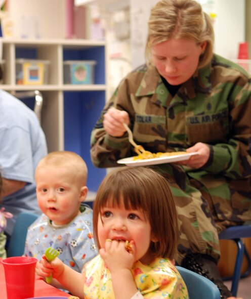 FAIRCHILD AIR FORCE BASE, Wash. -- Alicia Johnson, daughter of Senior Airman Maria Pardo, 92nd Maintenance Operations Squadron, and Senior Airman Brandon Johnson, 93rd Air Refueling Squadron; and Evan Tolar, son of Tech. Sgt. Jennifer Tolar (pictured in the background), 92nd Aeromedical Dental Squadron, and Tech. Sgt. Shawn Tolar, 92nd Logistics Readiness Squadron, eat lunch during the Child Development Center’s Spaghetti Feed April 21. As part of the event, the CDC invited parents to eat lunch with their children. About 60 parents showed up to take part in the lunch. (U.S. Air Force photo/Capt. Jason McCree)
