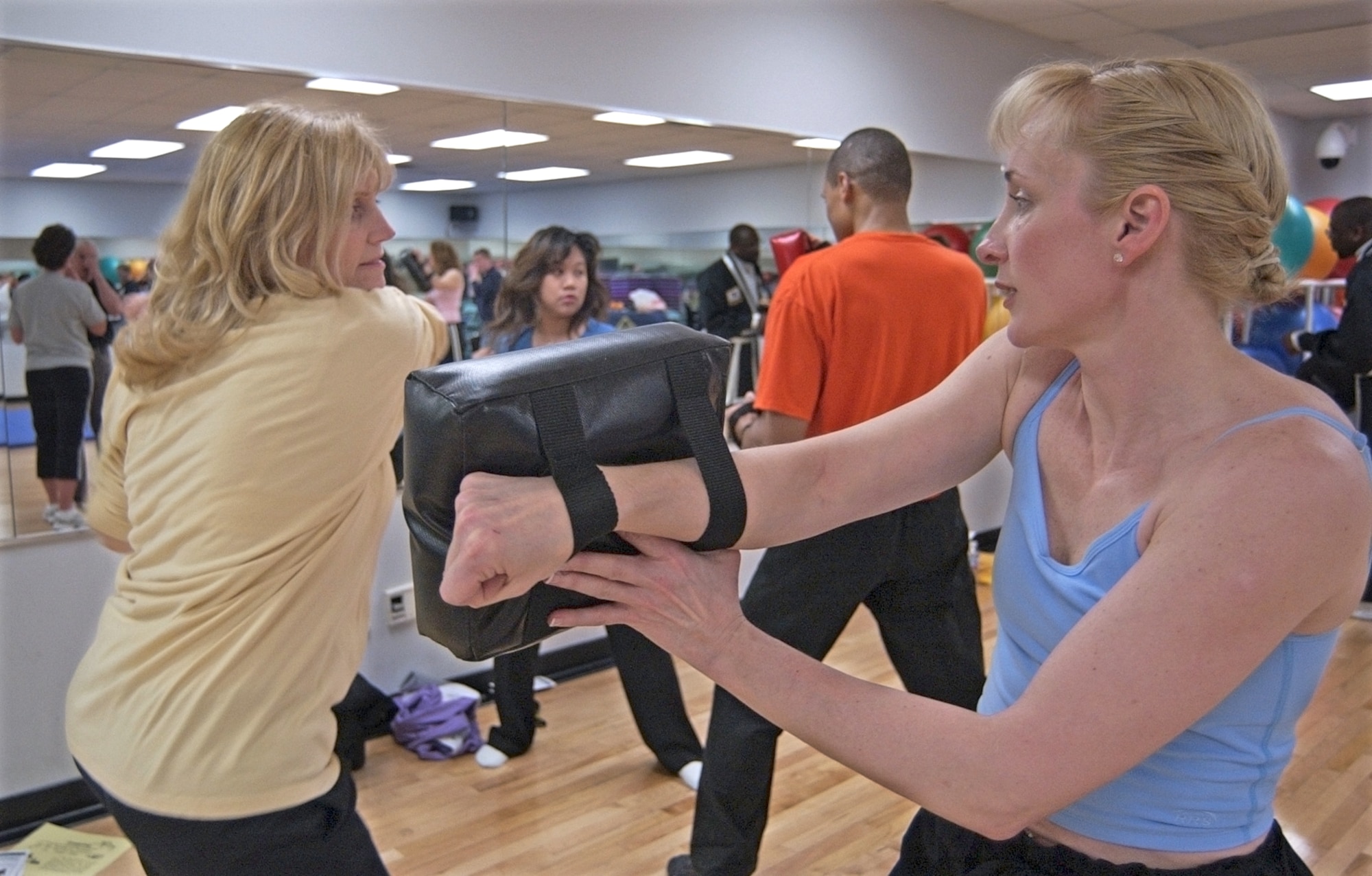 WRIGHT-PATTERSON AIR FORCE BASE, Ohio -- Toni Tebbing, left, with the National Air and Space Intelligence Center, winds up for an elbow blow into the pad held by Karen Douglas at the Sexual Assault Response Coordinator women’s self-defense class April 10. (U.S. Air Force/Spencer P. Lane)