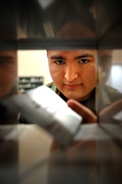 Senior Airman Mario Carranza is one of the postal clerks who work in the post office maintaining 6,000 mailboxes and processing more than 1,000 pieces of mail daily. The post office staff not only needs special duty Airmen, but welcomes the help of base volunteers. (U.S. Air Force photo by Staff Sgt. Tyrona Pearsall) 
