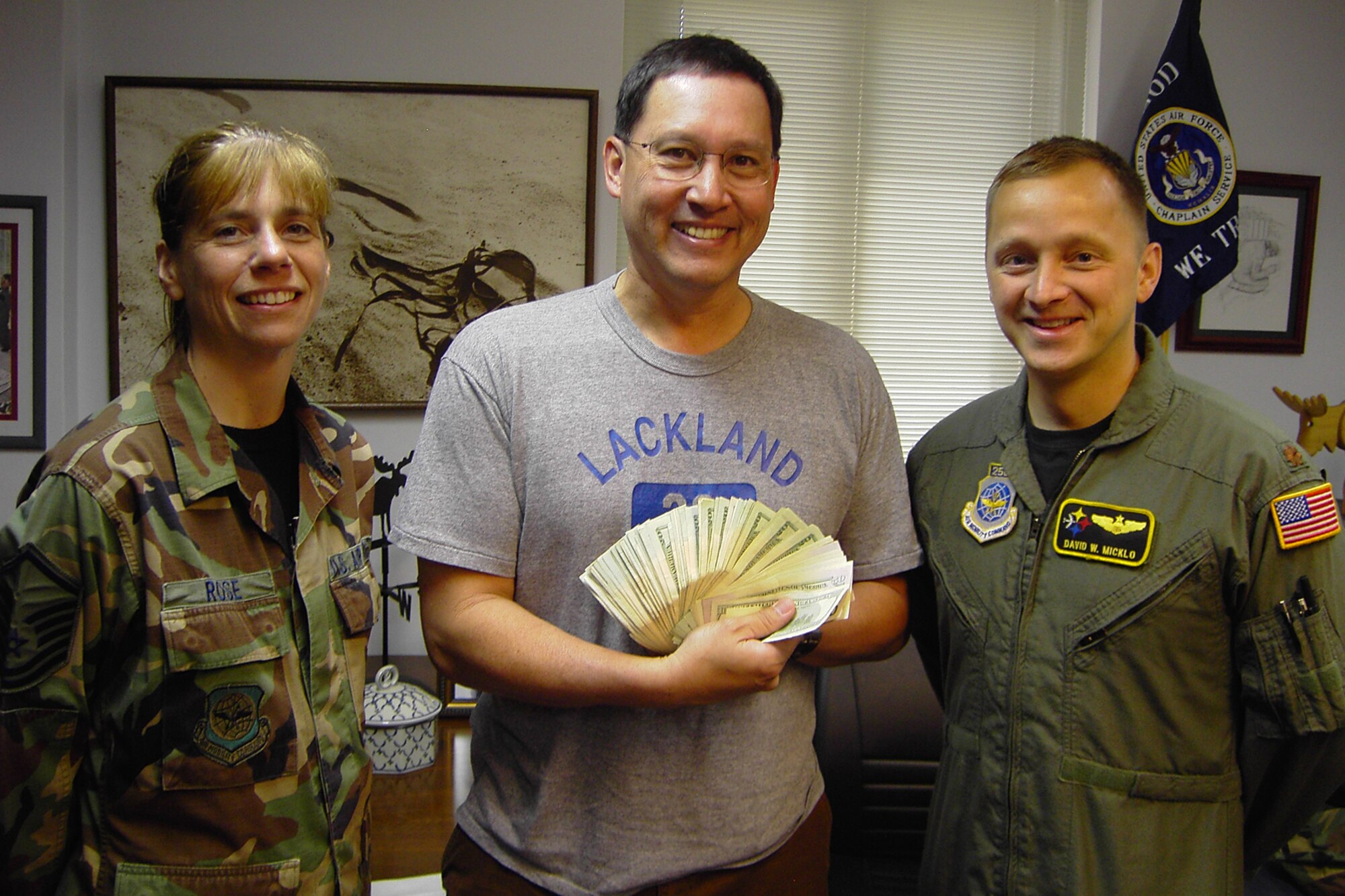 Chap. (Maj.) Kenneth Reyes, 39th Air Base Wing, holds up $1,801 that was donated by members of the 385th Air Expeditionary Group, 21 April. Maj. David Micklo, 385th AEG operations officer, and Master Sgt. Kimberely Rose, 385th AEG administrative support assistant, ran a total of 57 miles within 12 hours to raise money for the Seyhan School for the Hearing Impaired.  (U. S. Air Force photo by 1st Lt. Rose Richeson)