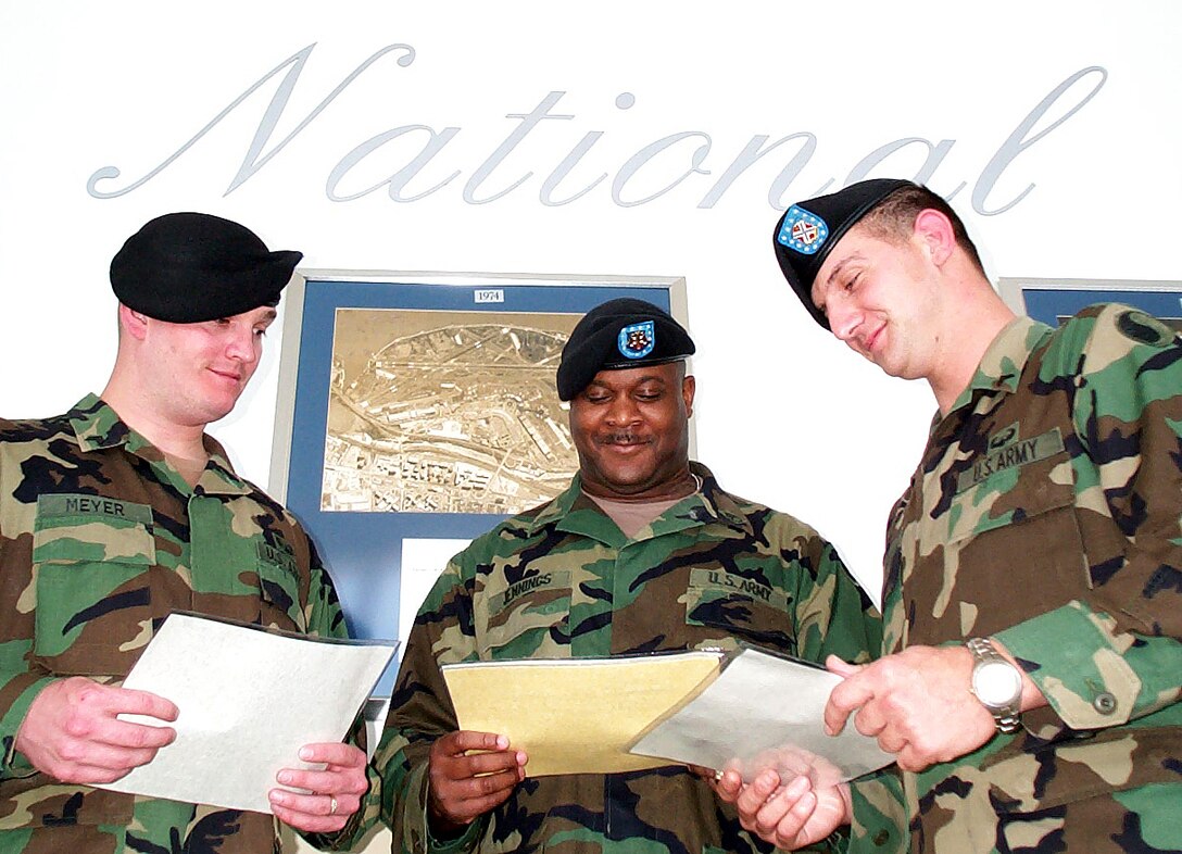 Army National Guard 29th Infantry (Light) Division troops Sgt. Charles Meyer, Staff Sgt. Eric Jennings, and Cpl. James Davis admire their certificates of achievement May 10 provided by Christopher U. Browne, vice president and manager of Ronald Reagan Washington National Airport. The National Guardsmen are preparing to leave Reagan-National Sunday after almost eight month's of security duty at the airport. Photo by Gerry J. Gilmore