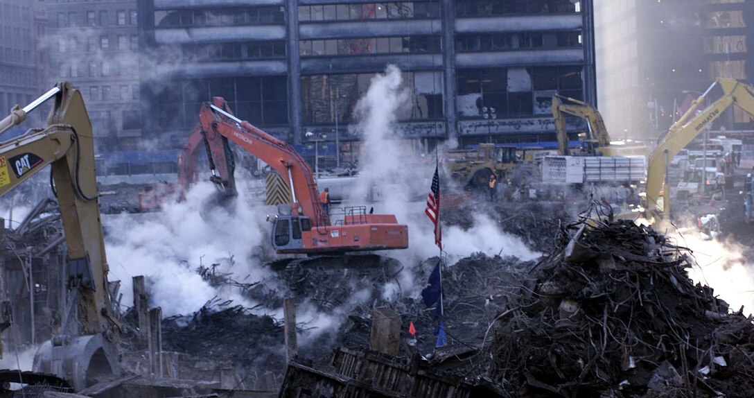 Clean-up crews continue their work at  "Ground Zero," the World Trade Center site in New York,  more than two months after terrorists slammed hijacked  airliners into the two towers. The photograph was not taken  from the air, but from the edge a large, deep hole cleared  of wreckage. Photo by Rudi Williams.