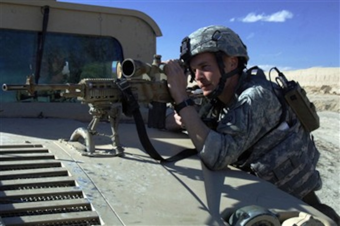 U.S. Army Sgt. Klye Edwards, from Reconnaissance Platoon, 2nd Battalion, 508th Parachute Infantry Regiment, looks through the scope of his rifle onto a mortar range near Ghazni, Afghanistan, on April 1, 2007.  