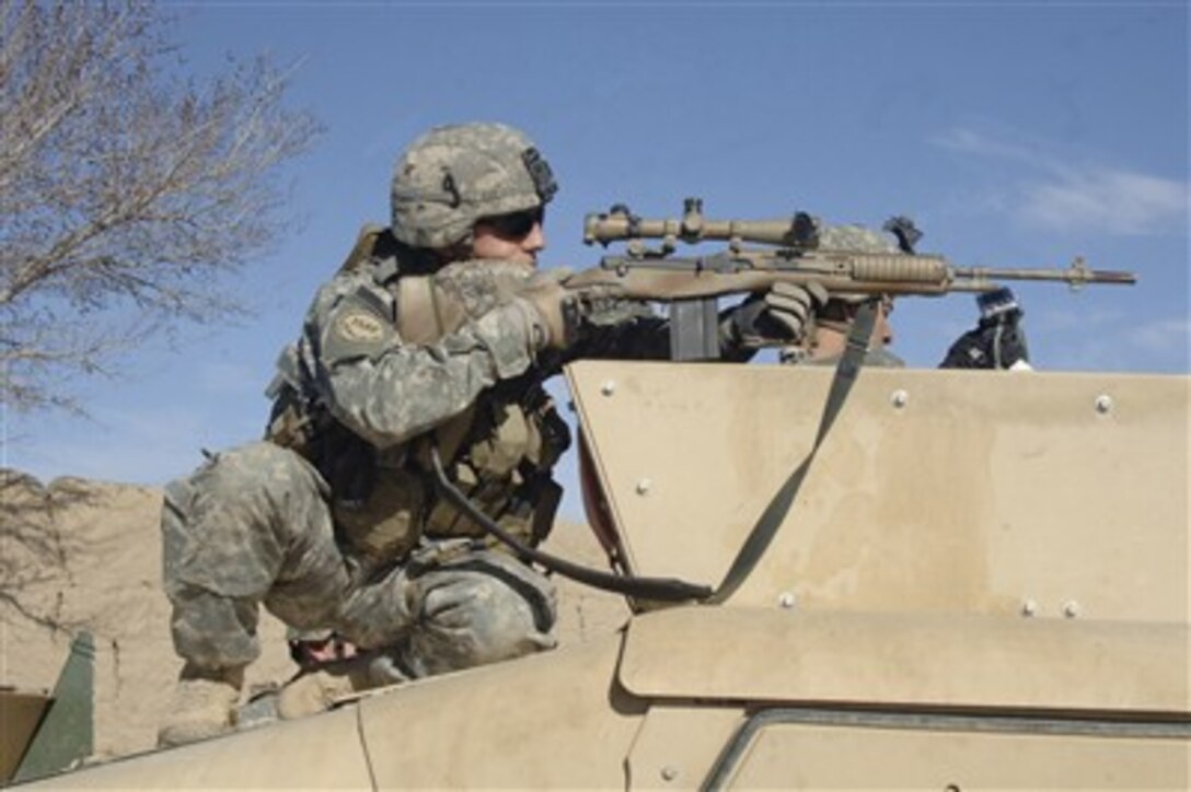 U.S. Army Sgt. Colin Cleek, from Reconnaissance Platoon, 2nd Battalion, 508th Parachute Infantry Regiment, looks through the scope of his rifle onto a mortar range near Ghazni, Afghanistan, on April 1, 2007.  