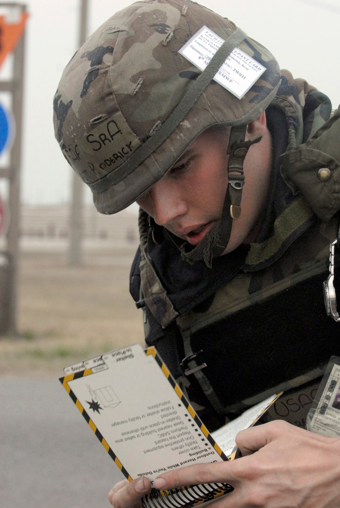 KUNSAN AB, Republic of Korea -- Senior Airman Brett Roderick, 8th Maintenance Squadron, refers to his Airman's Manual to find proper treatment procedures for burns during a exercise scenario here April 17. The 8th Fighter Wing is currently undergoing an operational readiness inspection to test its ability to conduct its wartime mission. (U.S. Air Force photo by Senior Airman Darnell T. Cannady)