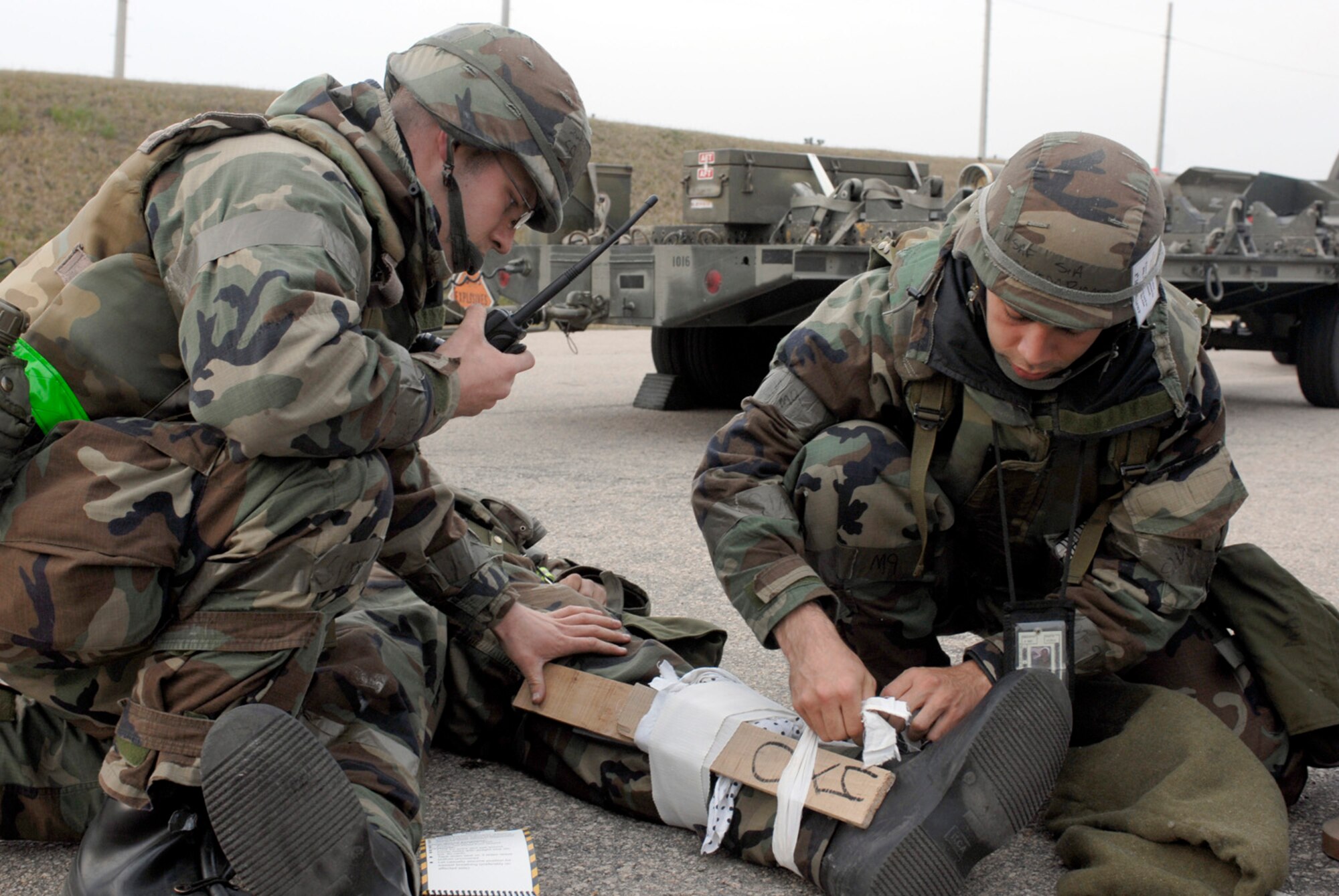 KUNSAN AB, Republic of Korea -- Senior Airmen James Herzog and Ricardo Sepulveda splint the leg of injured Senior Airman Sean Simon-Okpealuk, during a self Aid Buddy Care scenario here April 17. All Airmen are from the 8th Maintenance Squadron. The 8th Fighter Wing is currently undergoing an operational readiness inspection to test its ability to conduct its wartime mission. (U.S. Air Force photo by Senior Airman Darnell T. Cannady)