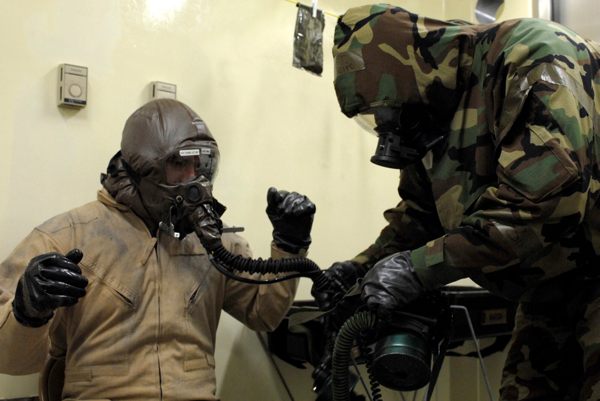 KUNSAN AB, Republic of Korea ? Tech. Sergeant Luis Pineiro, 35th Fighter Squadron, checks the oxygen line of 1st Lt. Nathan Froh, 35th Fighter Squadron pilot, during the pilot?s decontamination here. The 8th Fighter Wing is currently undergoing an operational readiness inspection to test its ability to conduct its wartime mission. (U.S. Air Force photo by Senior Airman Darnell T. Cannady)