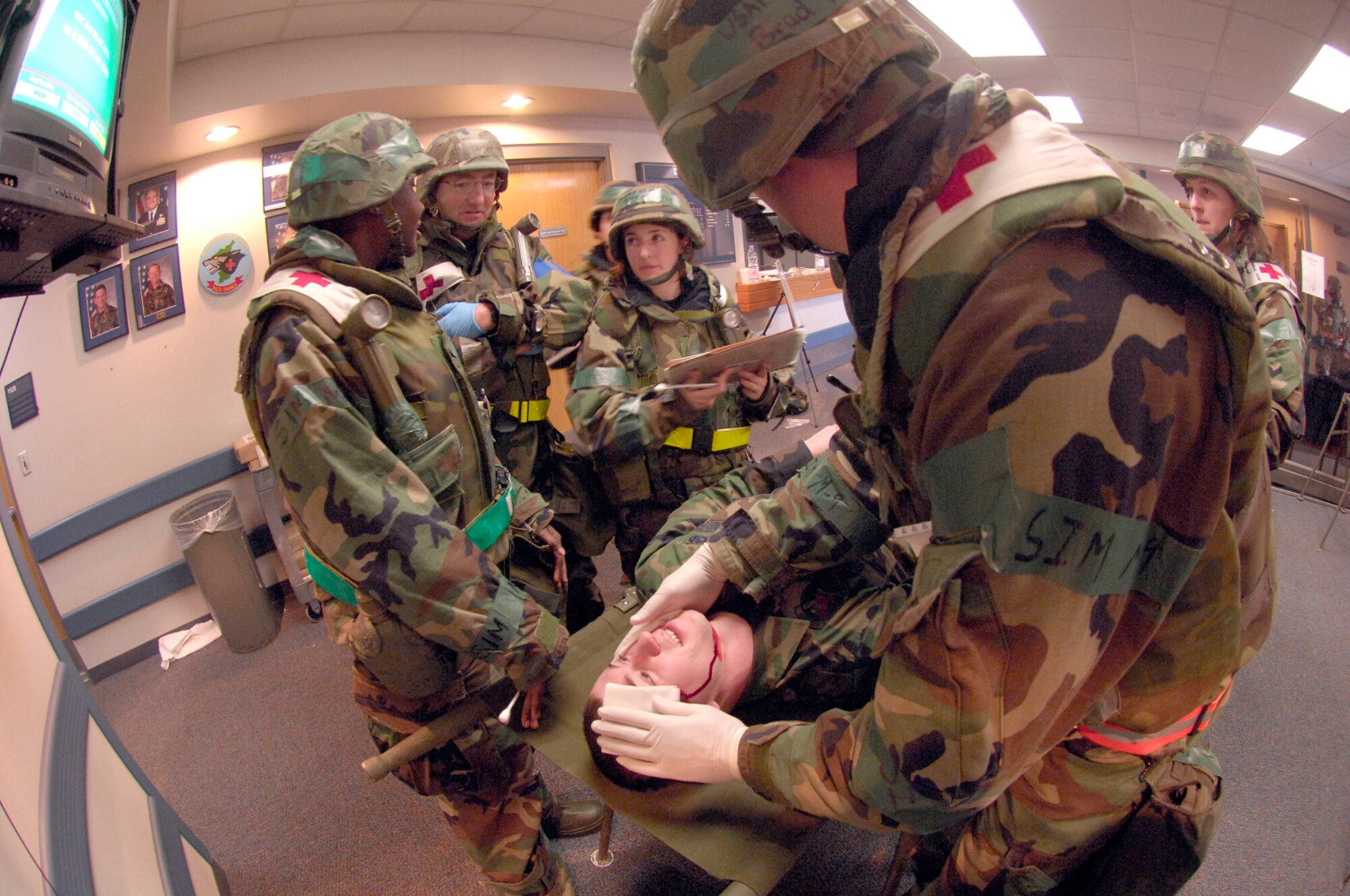 KUNSAN AB, Republic of Korea -- Doctors from the 8th Medical Group perform treatment on a patient for simulated injuries during an inspection here April 18. The 8th Fighter Wing is currently undergoing an operational readiness inspection to test its ability to conduct its wartime mission.  (U.S. Air Force Photo by Master Sgt Jack Braden.)