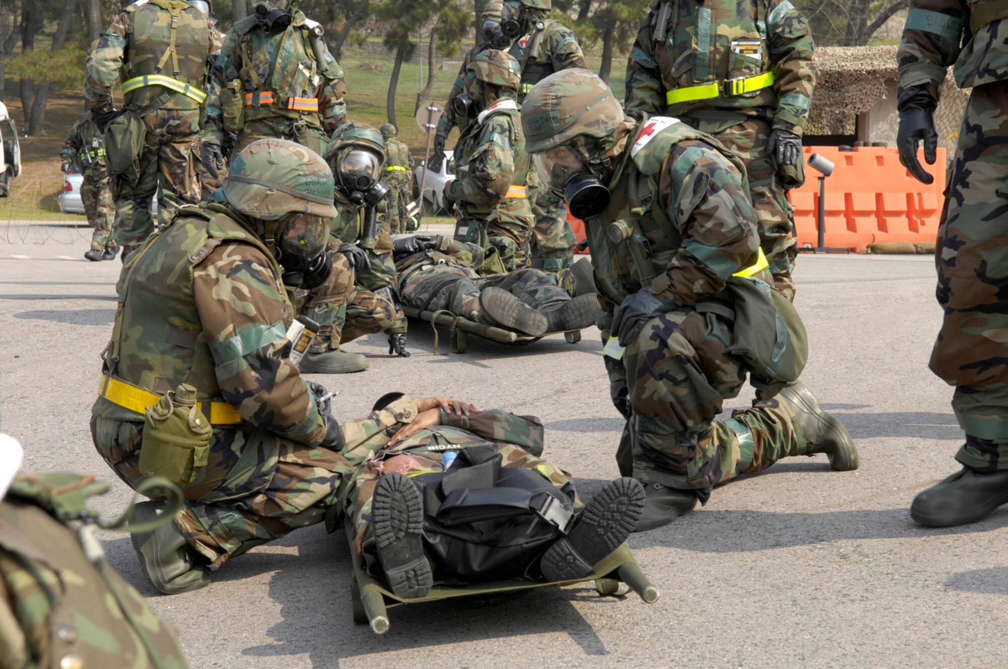 KUNSAN AB, Republic of Korea -- Medics from the 8th Medical Group evaluate a patient with simulated injuries in order to perform emergency care during an inspection here April 18.  The 8th Fighter Wing is currently undergoing an operational readiness inspection to test its ability to conduct its wartime mission.  (U.S. Air Force Photo by Master Sgt Jack Braden.)