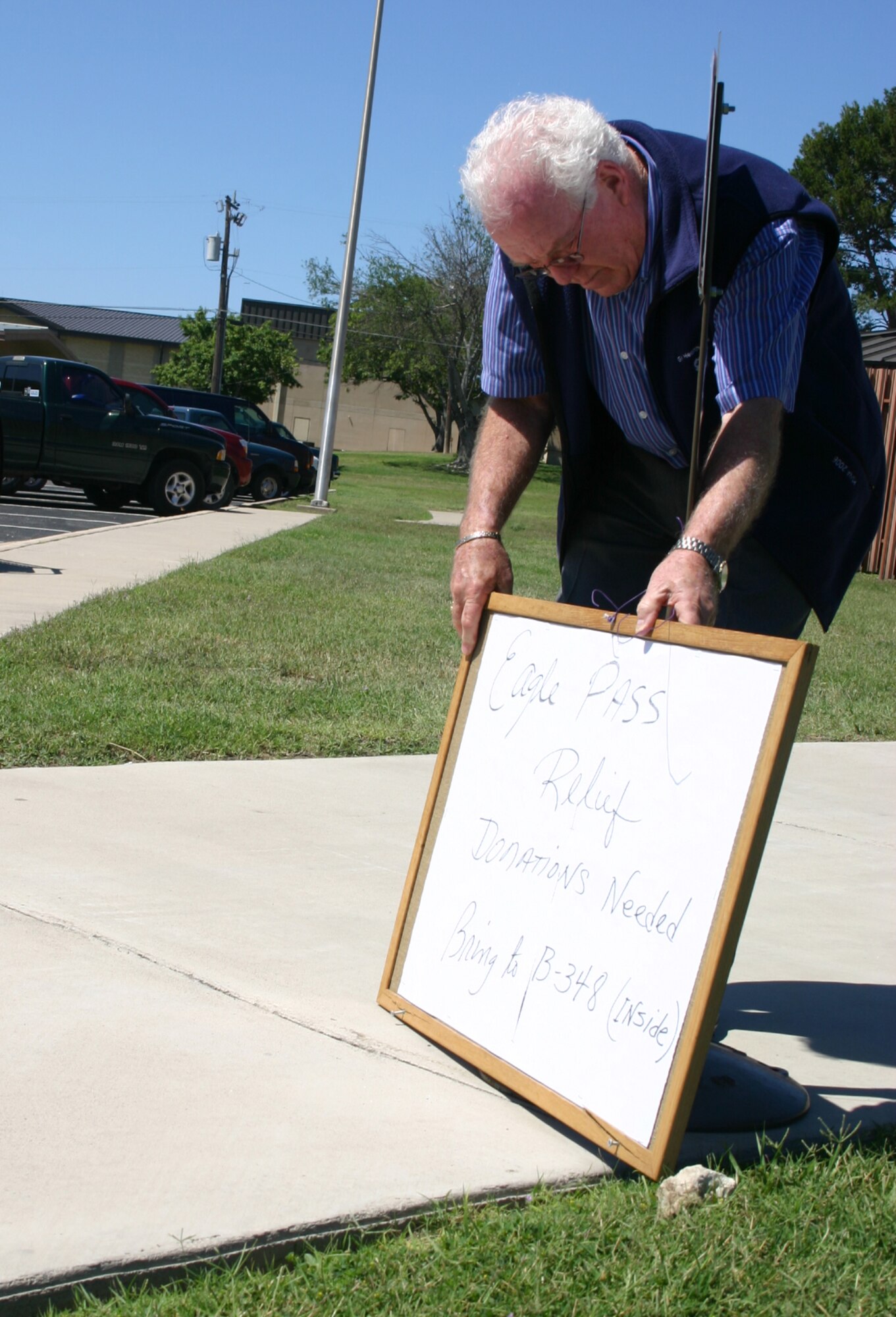 LAUGHLIN AIR FORCE BASE, Texas -- Hal Elkins, 47th Communications Squadron Deputy Director, sets up a collection point for Eagle Pass relief efforts in front of the 47th CS. 