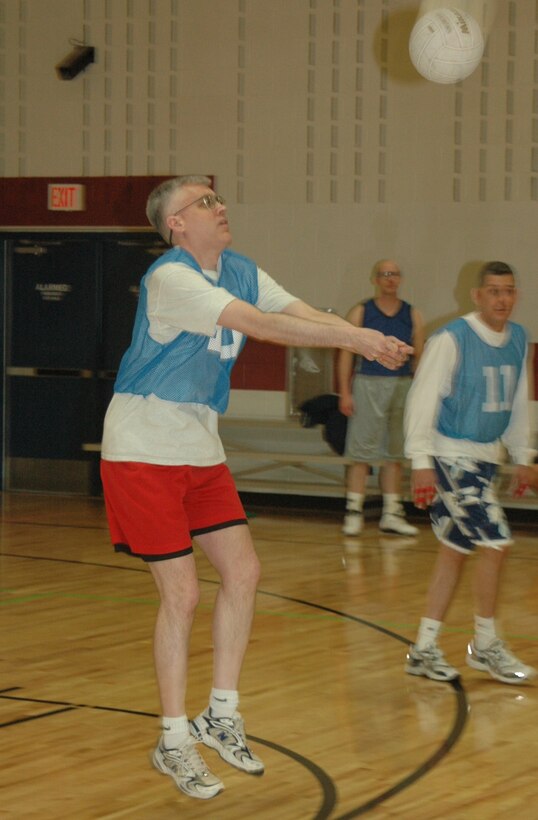 Members from the 28th Communications Squadron take on members from the 28th Munitions Squadron in an intramural volleyball match here at the Bellamy Fitness Center on April 24.  The 28th CS won the match by beating the 28th MUNS in the first 2 games.  (U.S. Air Force photo/Tech. Sgt. Todd Wivell)