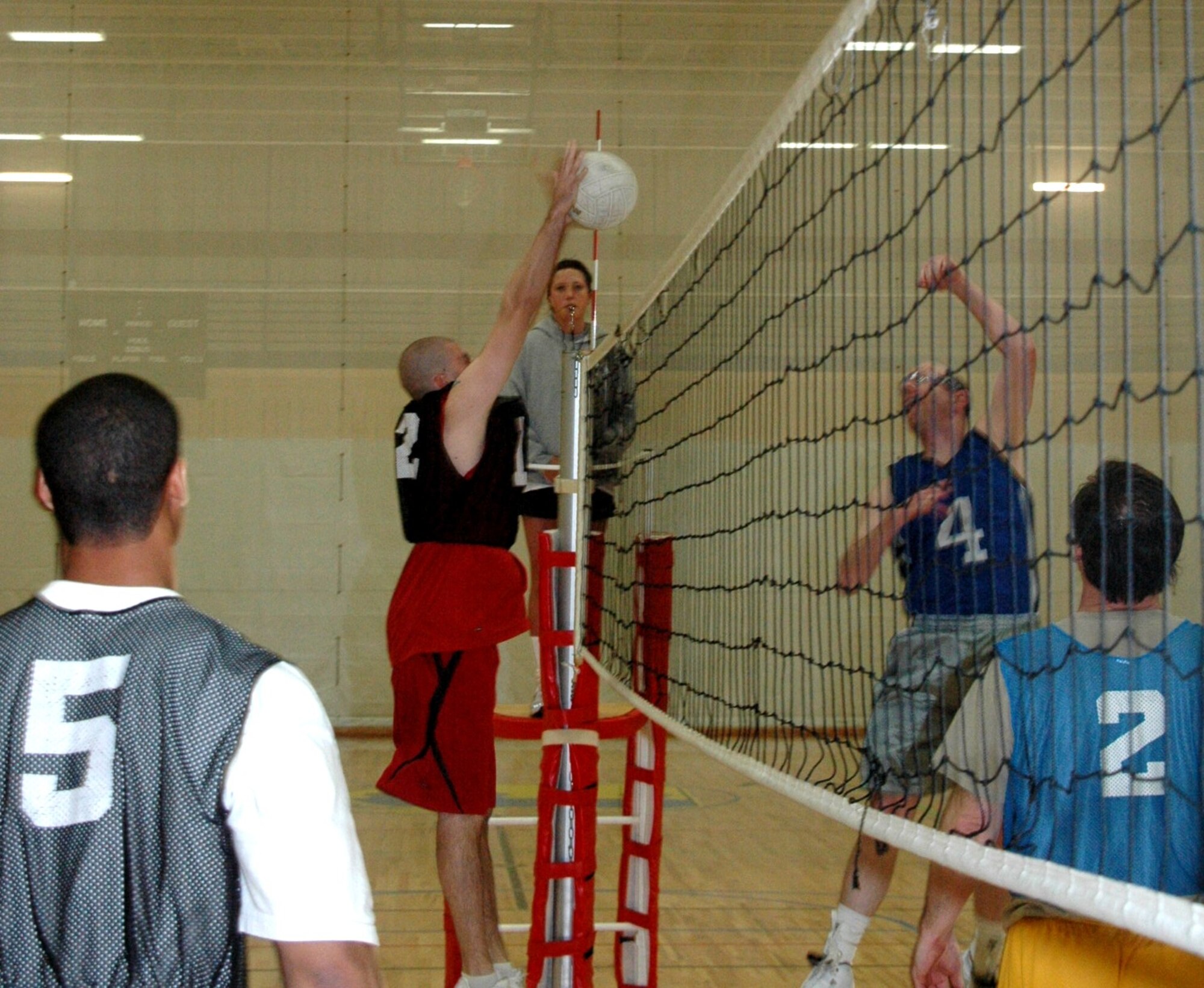 Members from the 28th Communications Squadron take on members from the 28th Munitions Squadron in an intramural volleyball match here at the Bellamy Fitness Center on April 24.  The 28th CS won the match by beating the 28th MUNS in the first 2 games.  (U.S. Air Force photo/Tech. Sgt. Todd Wivell)
