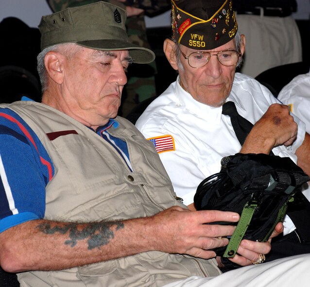 Marine Corps veteran and host of The History Channel's Mail Call, R. Lee Ermey (left) and Mr. Melvin Snyder, past commander of VFW Post 9550, inspect a portable lightweight battery developed by the Air Force Research Laboratory to reduce  weight borne by combat controllers in the field. (Photo by Chris Gulliford, AFRL/HE)