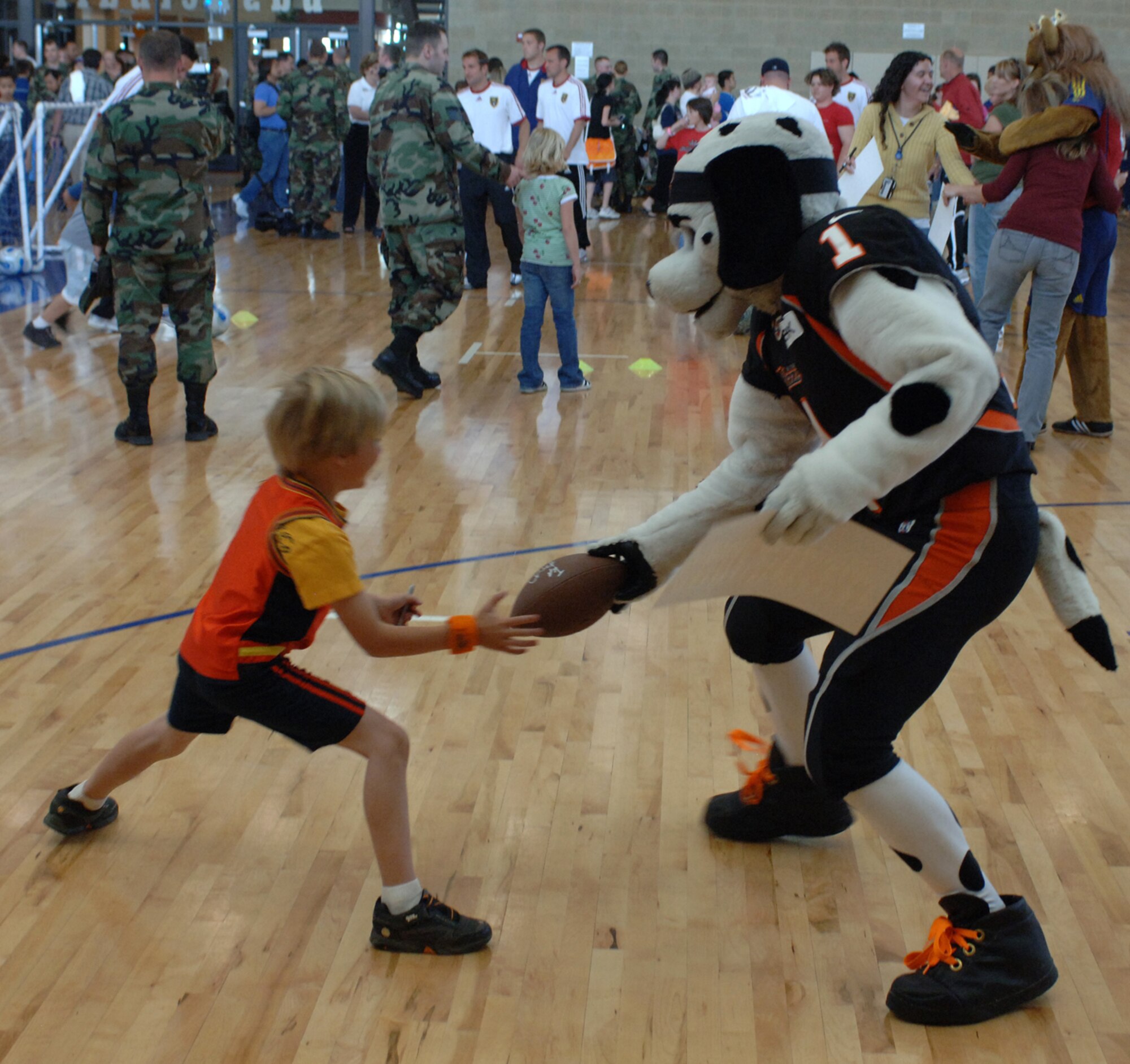 Utah Blaze mascot Chief Blaze plays keep away from a young fan trying to get an autographed football from him during the Salute to Team Hill held at the base fitness center. Photo by Alex R. Lloyd