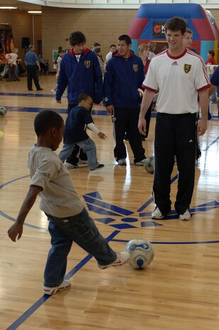 Real Salt Lake Player Kyle Brown practices passing the ball to a young soccer fan during the Salute to Team Hill held at the base fitness center. Photo by Alex R. Lloyd