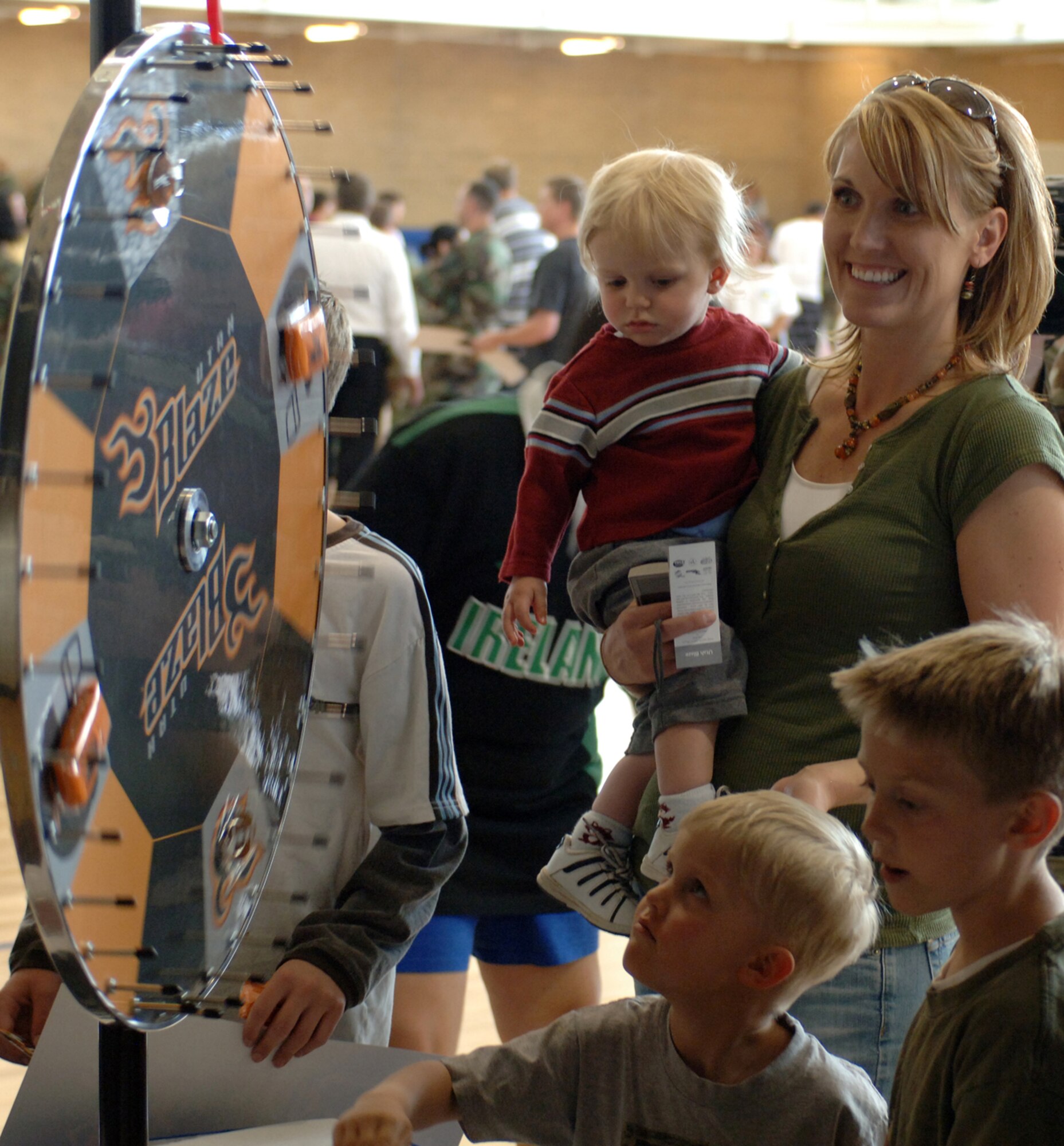 A Team Hill Family spins the Utah Blaze “Wheel of Prizes” during the Salute to Team Hill held at the base fitness center. Photo by Alex R. Lloyd