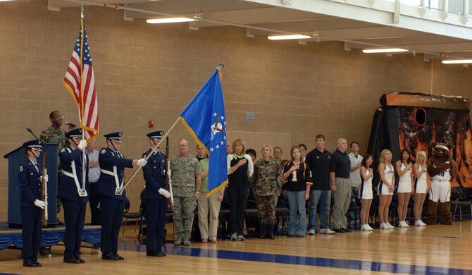 Capt Sean Carter, 75 ABW/PA sings the national anthem while the Northridge High School Jr. ROTC Honor Guard present the flag during the opening of the Salute to Team Hill held at the base fitness center. Photos by Alex R. Lloyd