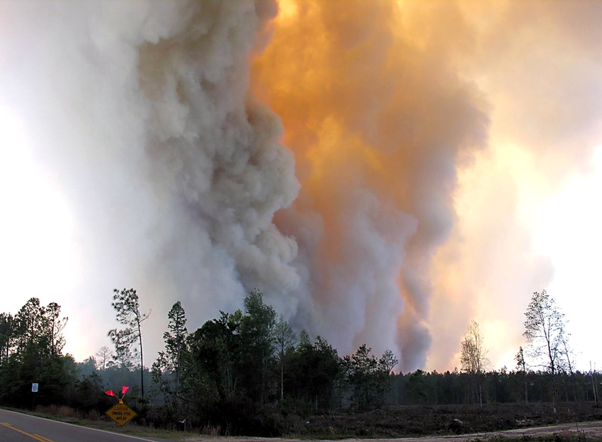 Smoke rises from a forest fire in southeastern Georgia. Moody Air Force Base firefighters have been supporting other fire departments to put out the fire since April 21. The 23rd Civil Engineer Squadron Fire and Emergency Services Flight are helping support local fire departments by ensuring they have sufficient amounts of water to put out the fires. By using tankers that can hold 5,000 gallons of water, up to five fire trucks can be filled. (U.S. Air Force photo/Senior Airman Javier Cruz)