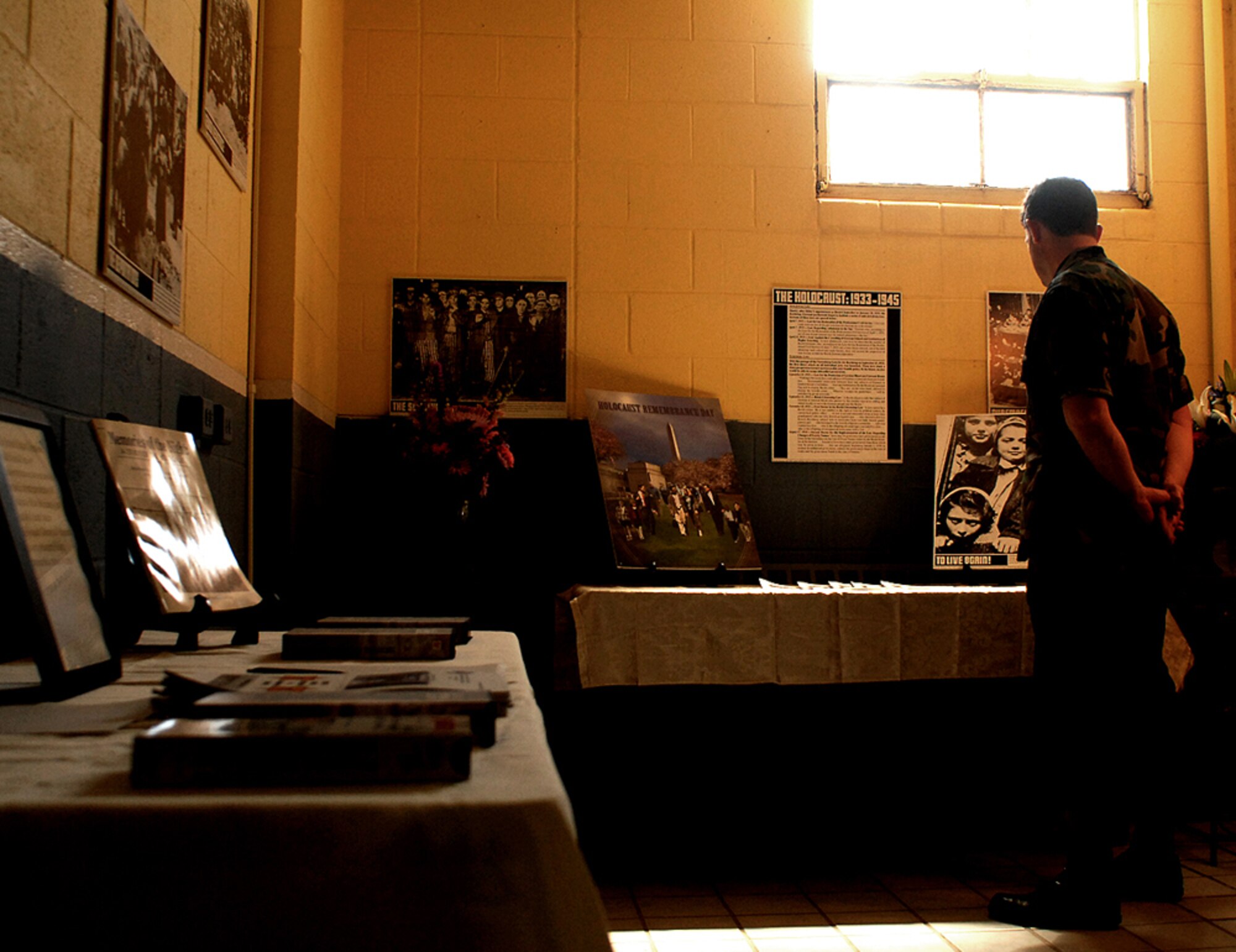 Chief Master Sgt. Charles Lafleur, 58th Aircraft Maintenance Squadron, looks at the base's Holocaust exhibit. The exhibit was at the Mini-mall last week.  U.S. Air Force photo by Todd Berenger