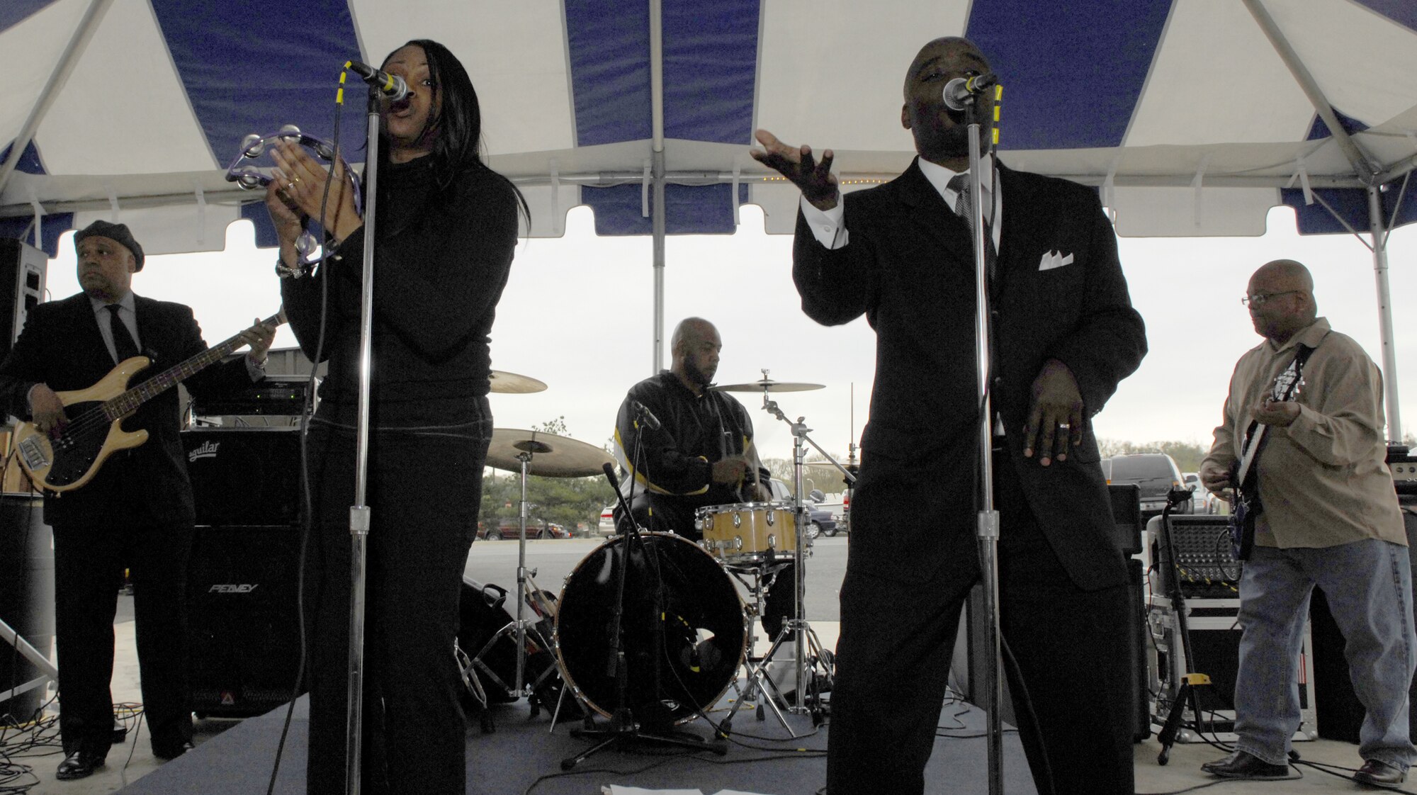 Wilma J. Bommer (left), 11th Civil Enigneer Squadron, performs with her band, The Change of Pace Band, at the Slip Inn April 18. The Slip Inn will have a live band or deejay every Wednesday and Friday from 4:30 to 8:30 p.m. throughout the summer. Change of Pace Band will be performing again April 27, May 11, May 30 and June 15. Master Sgt. Vincent Loran, also known as DJ Caribbean Breeze, will be performing during the Cinco de Mayo party May 4. (U.S. Air Force photo by Airman 1st Class Alexandre Montes) 