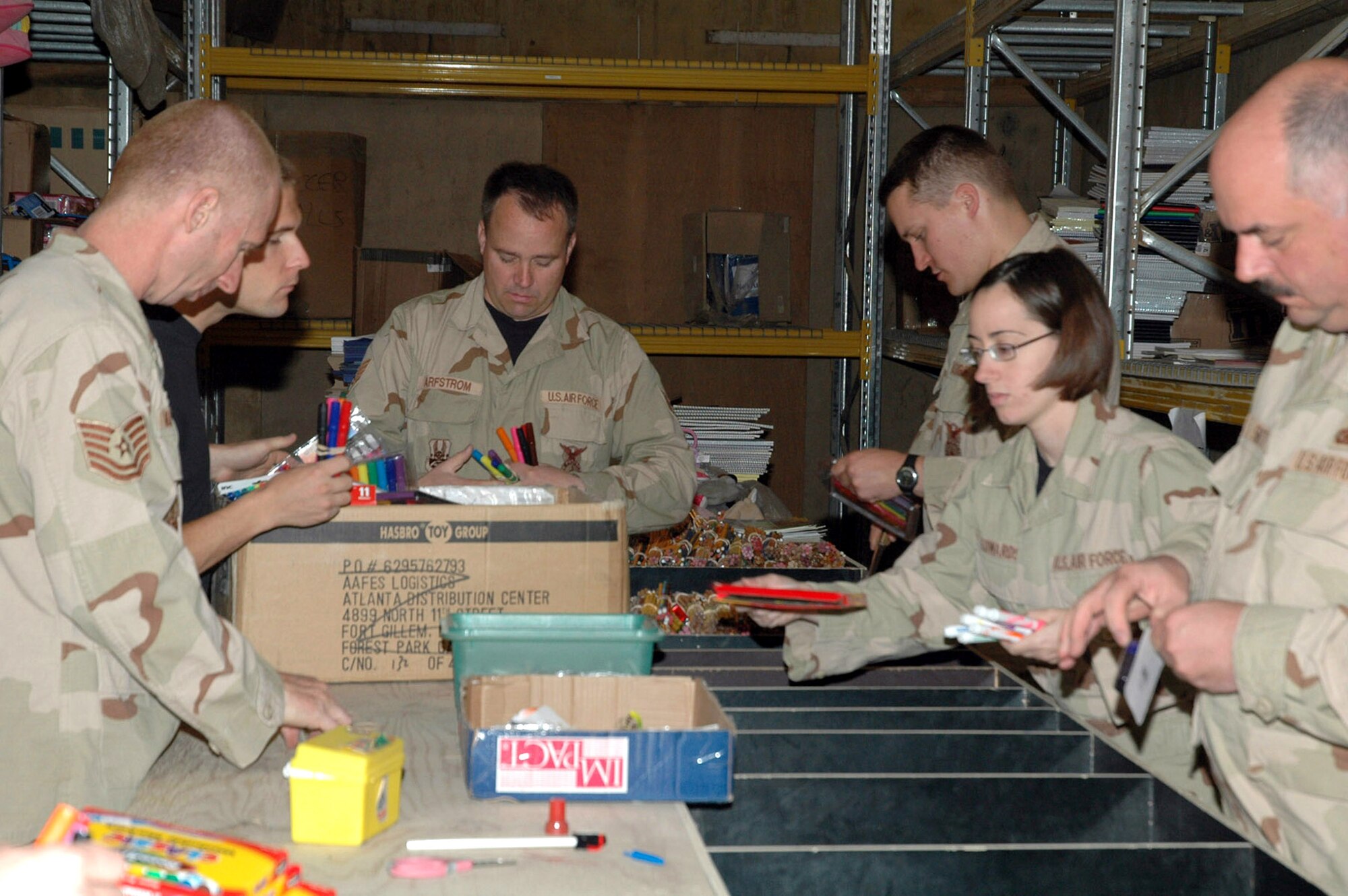 Volunteers sort through school supplies dontated by individuals and organizations in the U.S. for Operation School Supplies at Kirkuk Air Base, Iraq. The volunteers from the 506th Air Expeditionary Group, sorted, organized and delivered almost 5,000 pounds of school supplies since arriving in January. (U.S. Air Force photo/Tech. Sgt. Kevin Williams)
