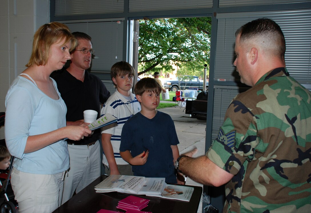 Maj. Kelli Niedzwiecki, 82nd Medical Operations Squadron, her husband C.J. and their sons Noah and Cobi talk to Tech. Sgt. Erich Lofton, Airmen and Family Readiness Flight noncommisioned officer, at the deployment expo April 24. (U.S. Air Force photo/Airman 1st Class Jacob Corbin)