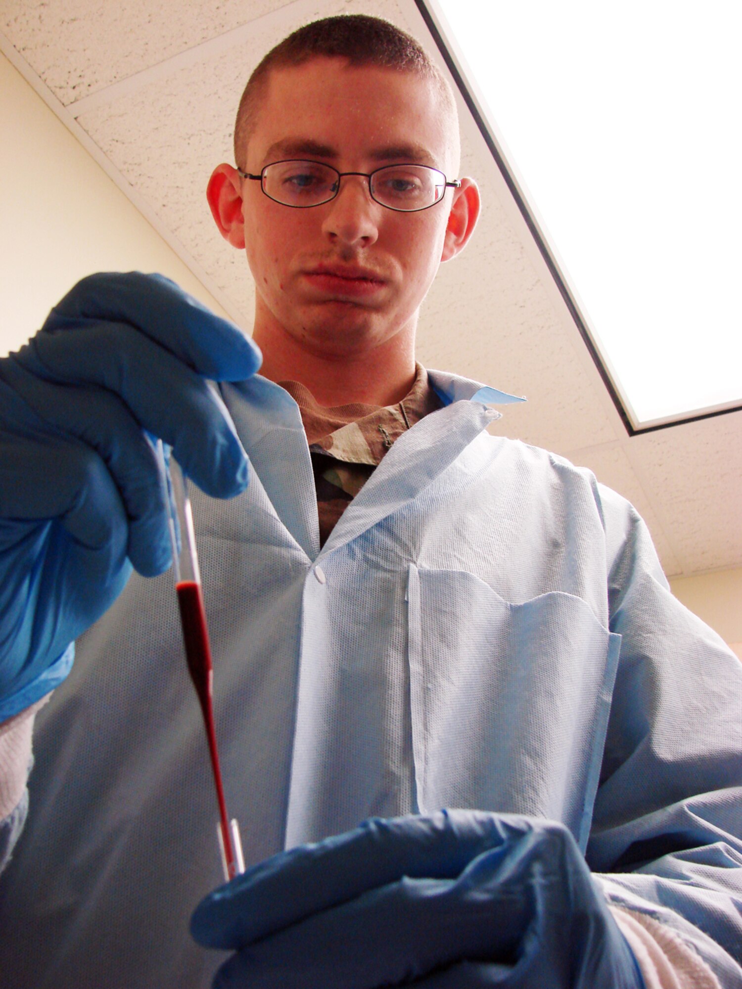 Senior Airman Christopher Nestor, 71st Medical Support Squadron laboratory technician, transfers a blood sample into a tube for a  sedimentation rate, a screening test for inflammatory diseases. The Vance AFB lab joined others across the country to celebrate National Medical Laboratory Professionals Week April 22 to 28. U.S.Air Force photo by Frank McIntyre 
