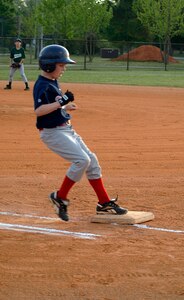 R.J. Keur, 11, son of Ronald, Youth Sports and Fitness Director, and Claudia Keur, makes it to base safely suring the Charleston AFB Braves' game against the Summerville Majors Wednesday.(U.S. Air Force photo/Staff Sgt. April Quintanilla)
