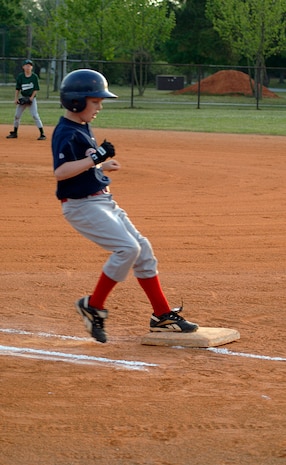 R.J. Keur, 11, son of Ronald, Youth Sports and Fitness Director, and Claudia Keur, makes it to base safely suring the Charleston AFB Braves' game against the Summerville Majors Wednesday.(U.S. Air Force photo/Staff Sgt. April Quintanilla)